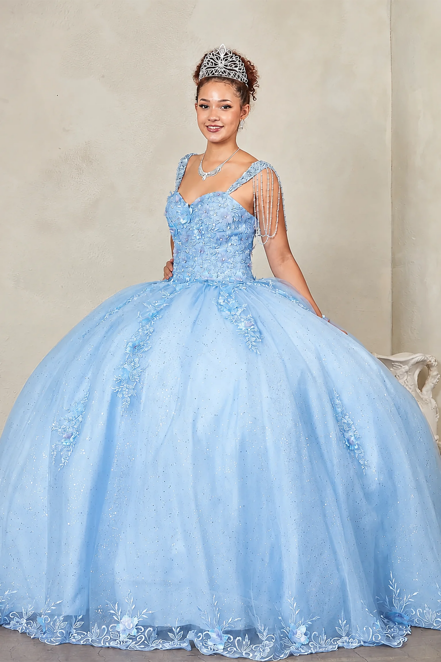 Blue quinceañera ball gown richly adorned with jewels, sequins, beads and intricate flower embroidery