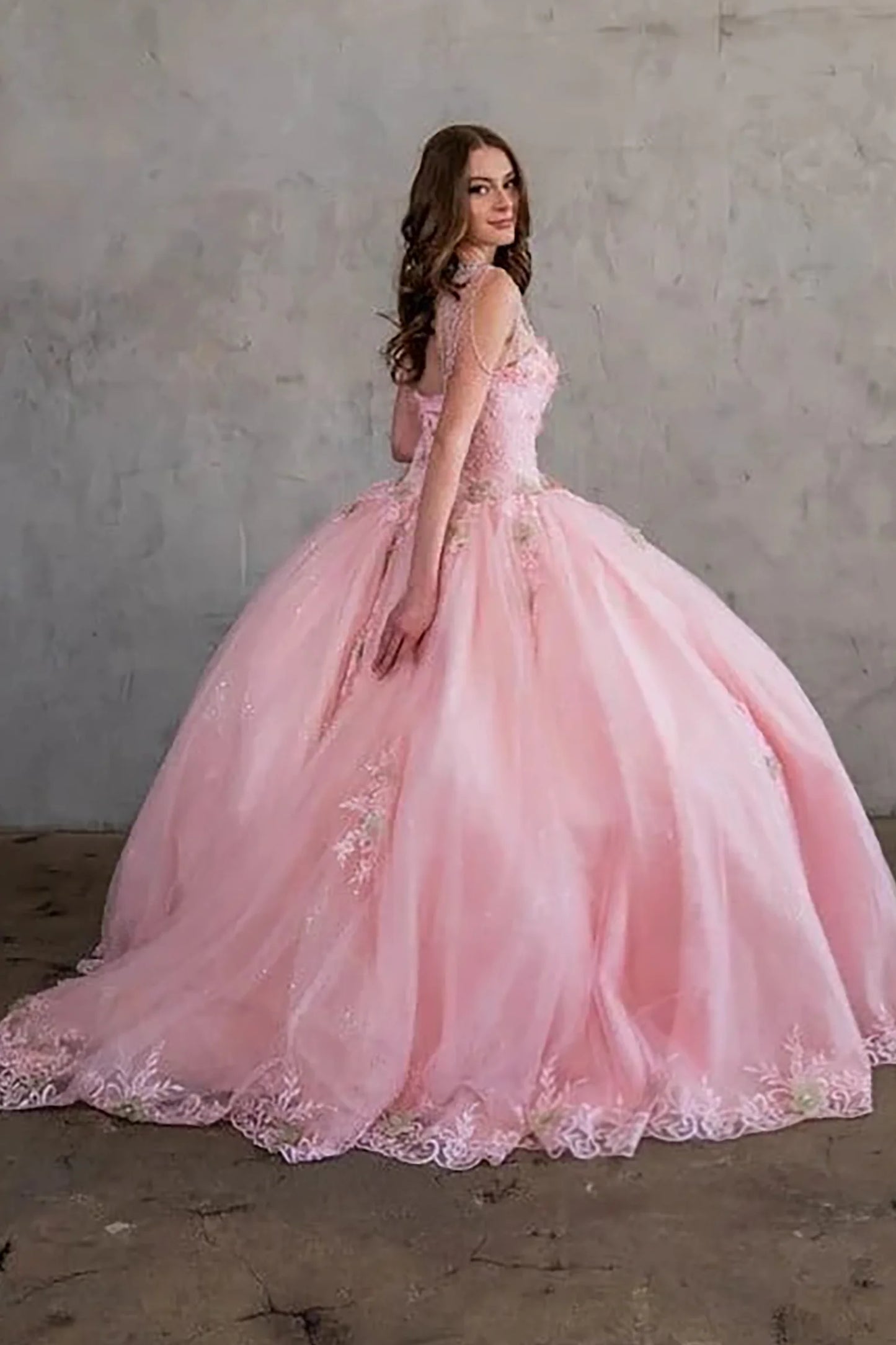 Blush quinceañera ball gown richly adorned with jewels, sequins, beads and intricate flower embroidery