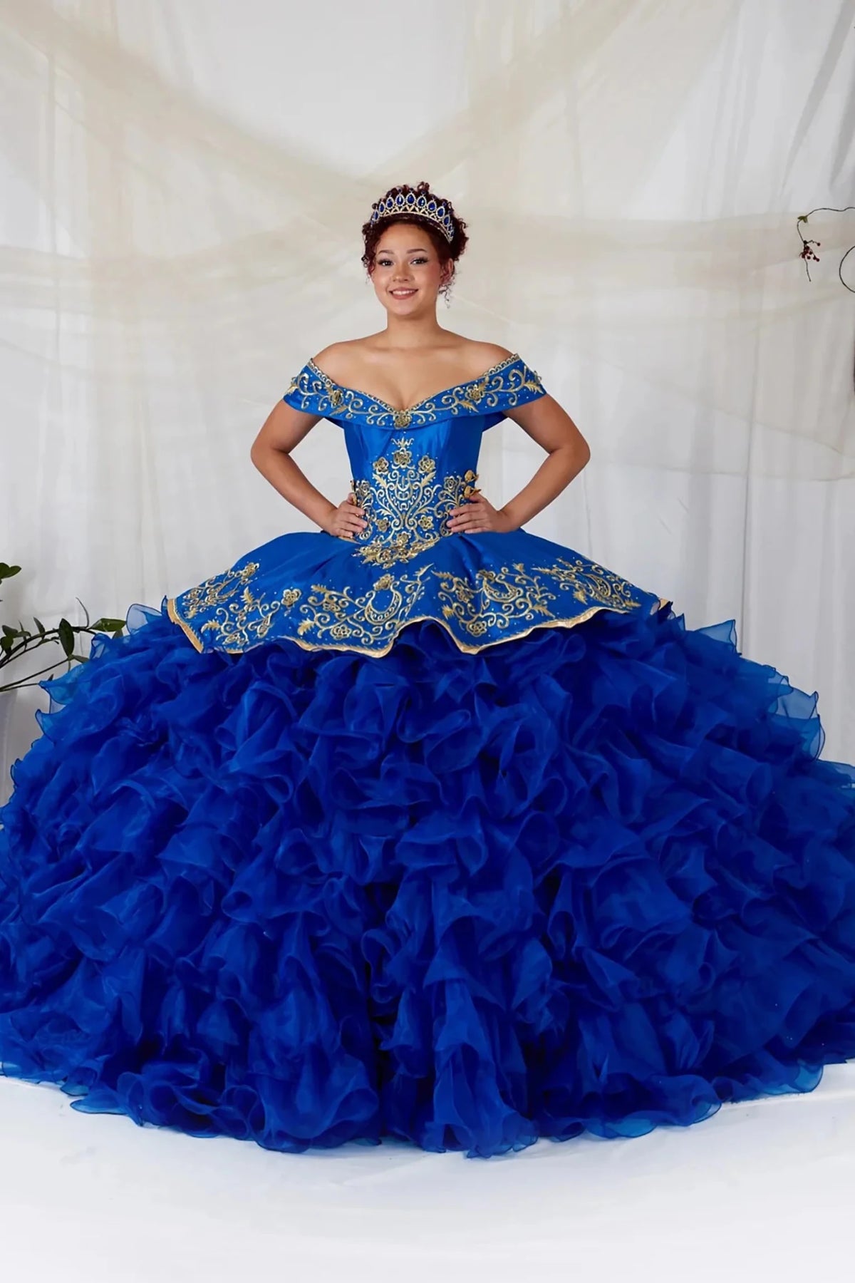 Royal blue quinceañera ball gown with gold embroidery, charra ruffle design and beaded bodice