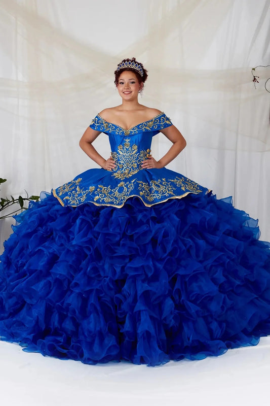 Bodice close-up highlights royal blue quinceañera ball gown with gold embroidery, charra ruffle design and beaded bodice.