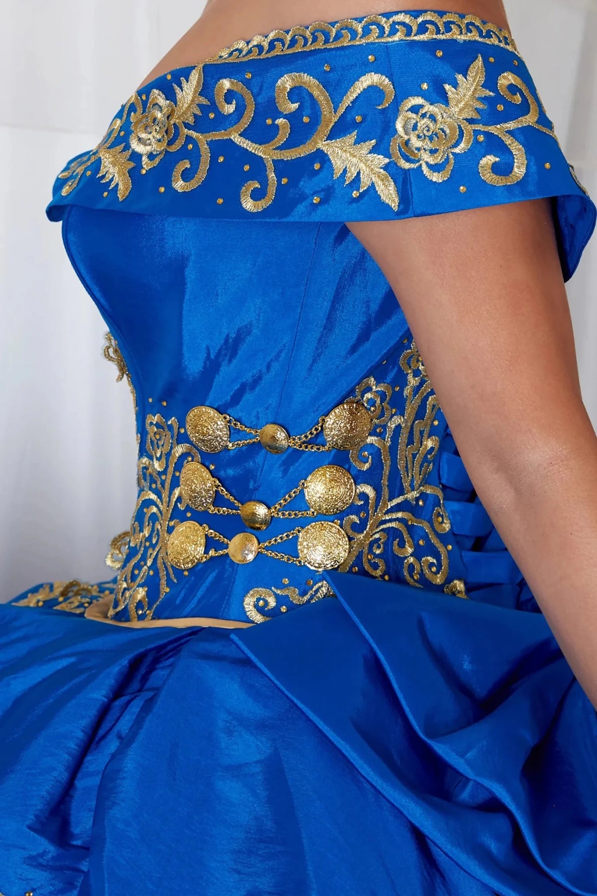Royal blue quinceañera ball gown with gold embroidery, charra ruffle design and beaded bodice