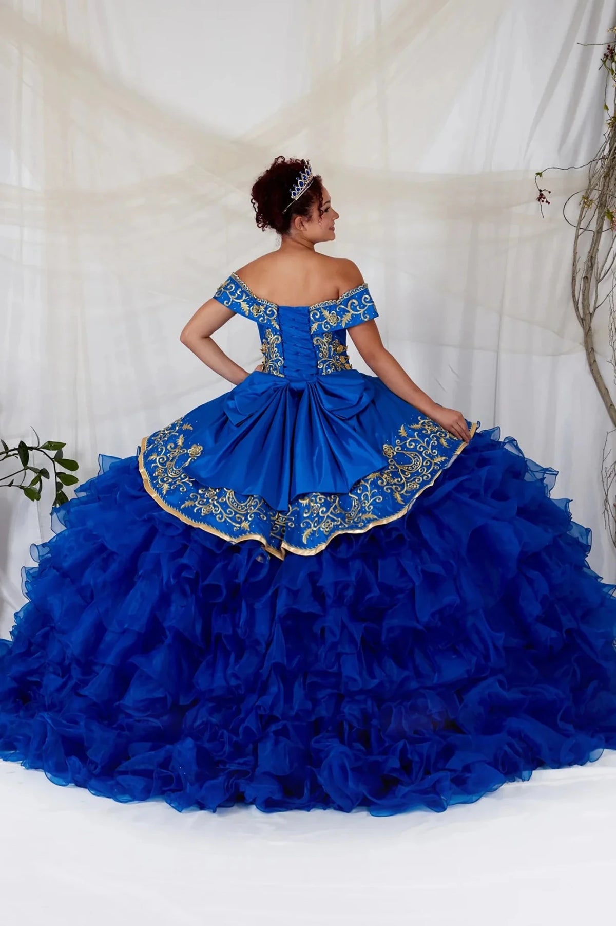 Royal blue quinceañera ball gown with gold embroidery, charra ruffle design and beaded bodice