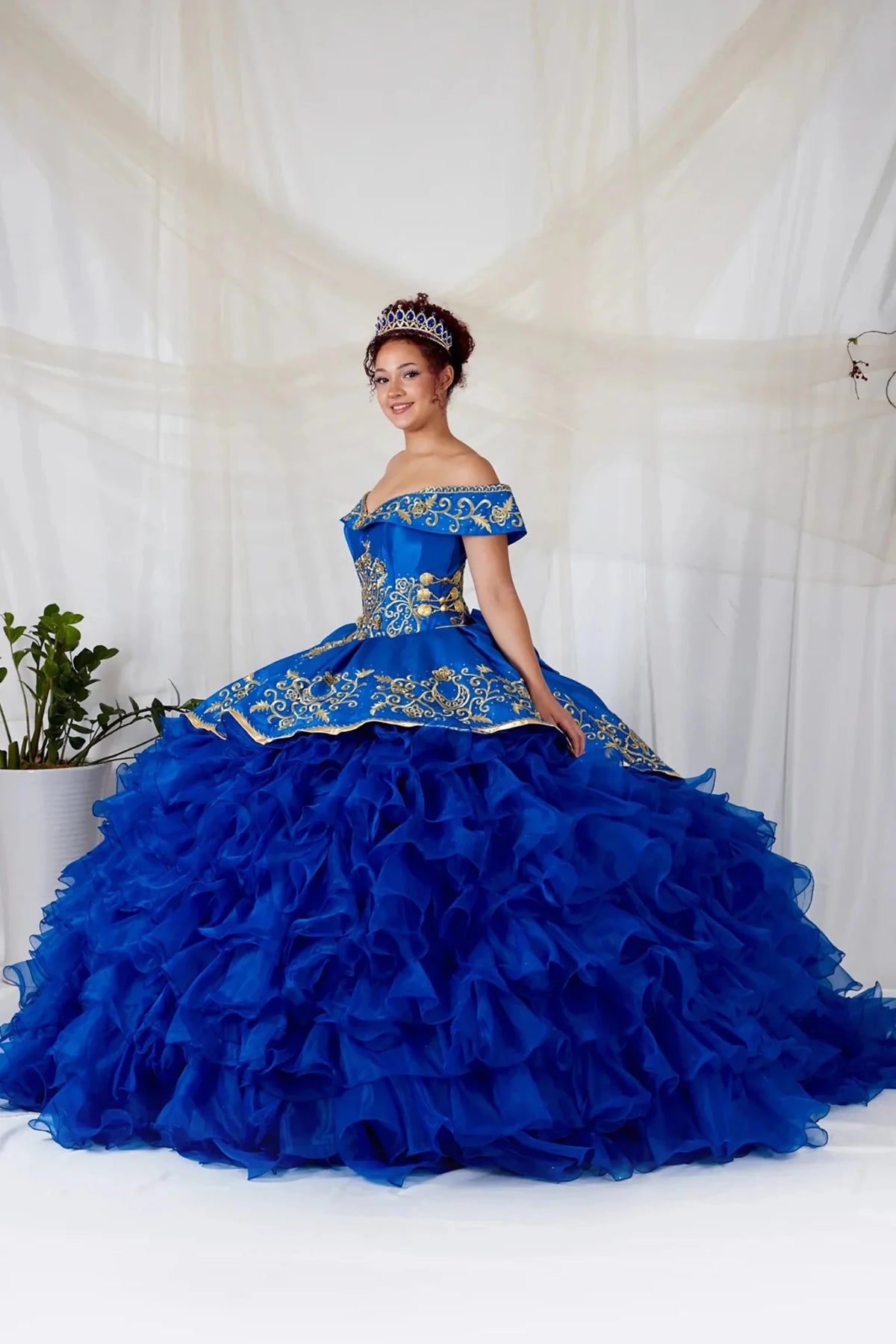 Royal blue quinceañera ball gown with gold embroidery, charra ruffle design and ruffled tulle layers