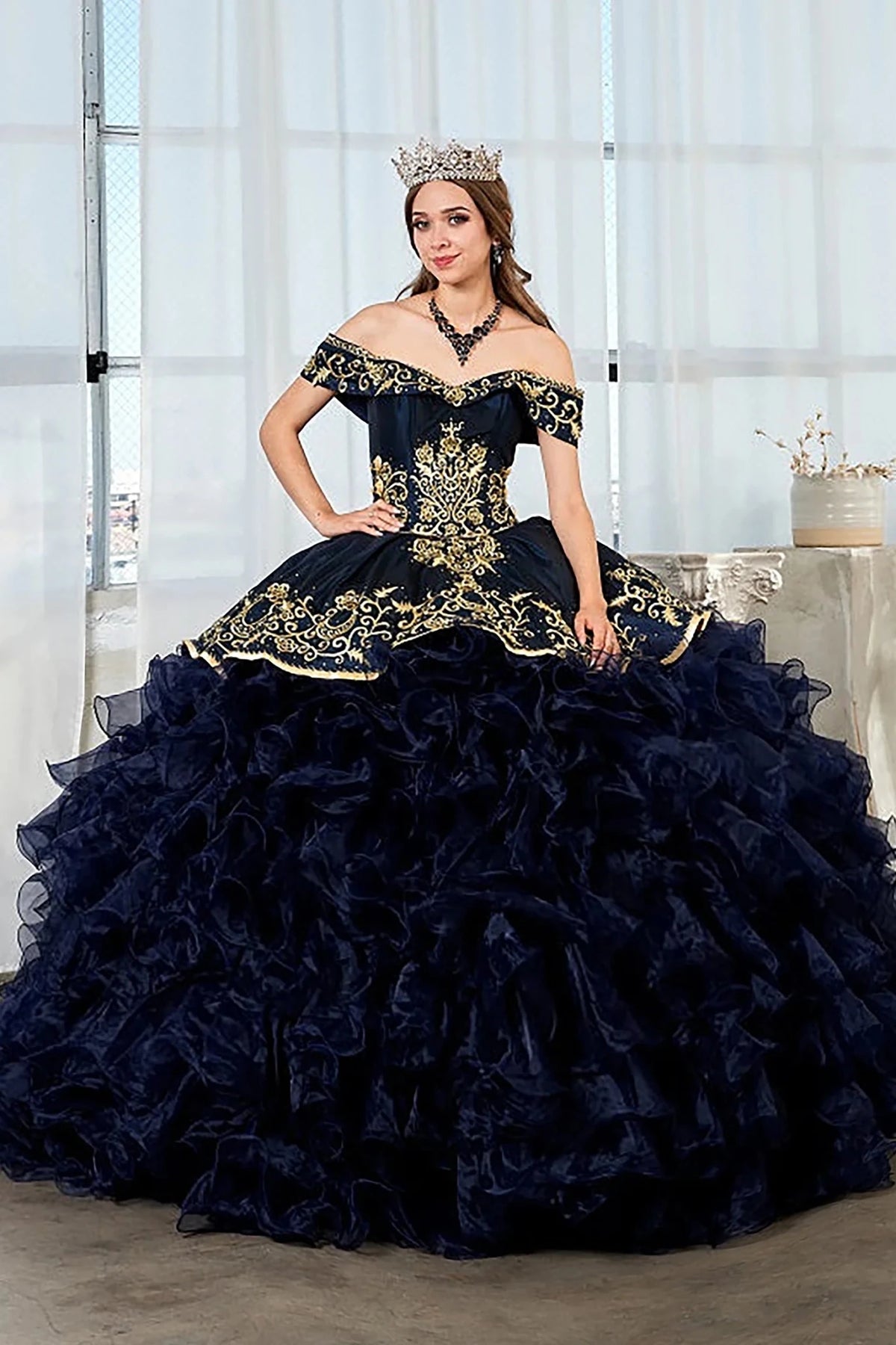Navy quinceañera ball gown with gold embroidery, charra ruffle design and beaded bodice