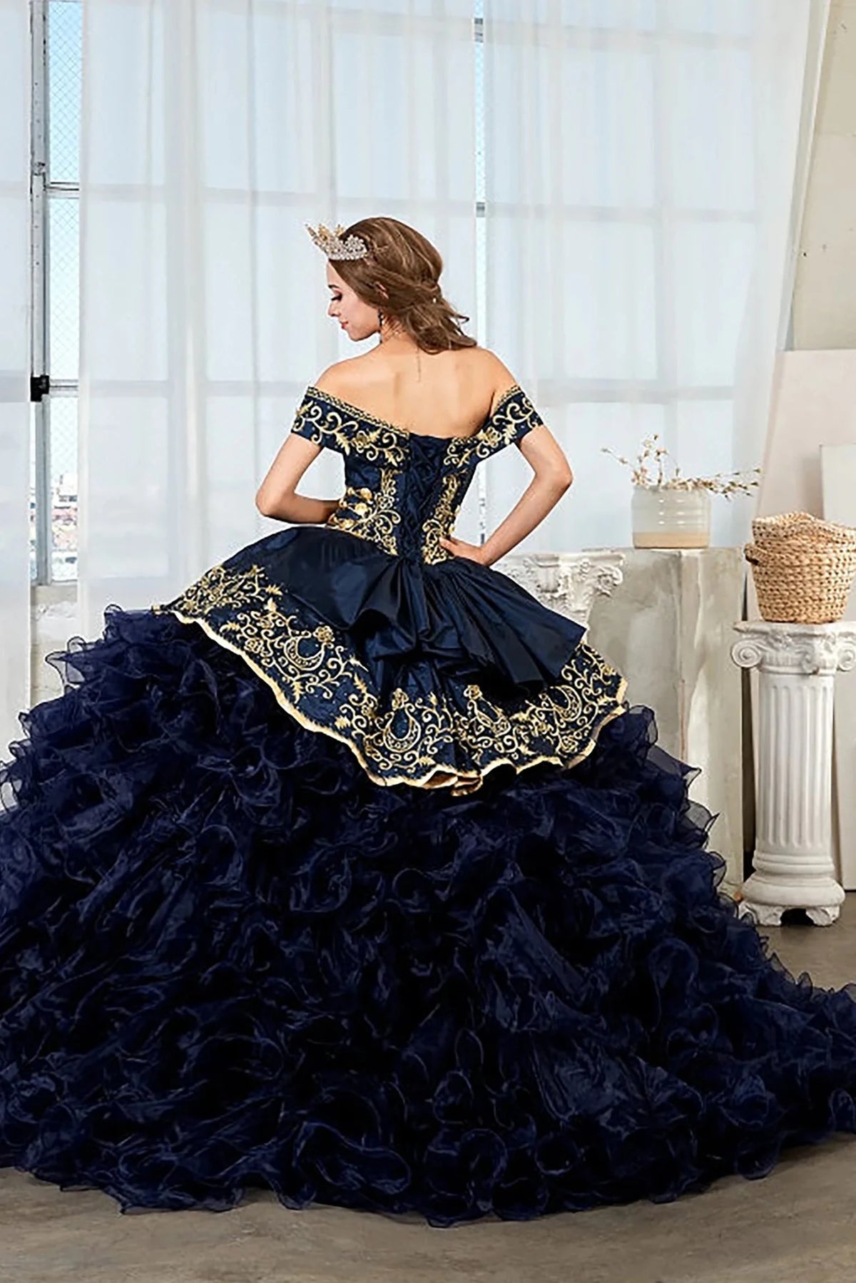 Navy quinceañera ball gown with gold embroidery, charra ruffle design and beaded bodice