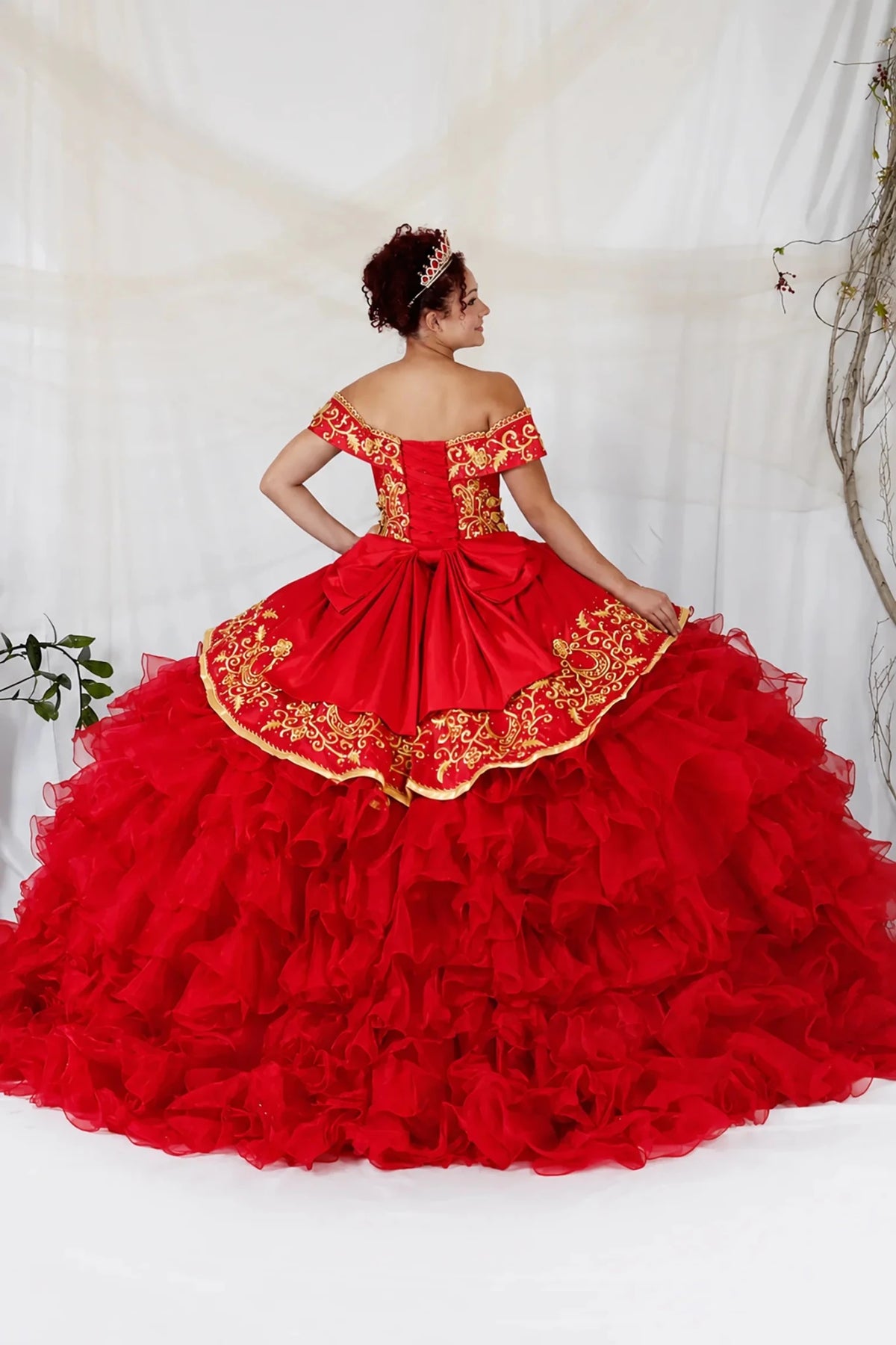 Red quinceañera ball gown with gold embroidery, charra ruffle design and beaded bodice