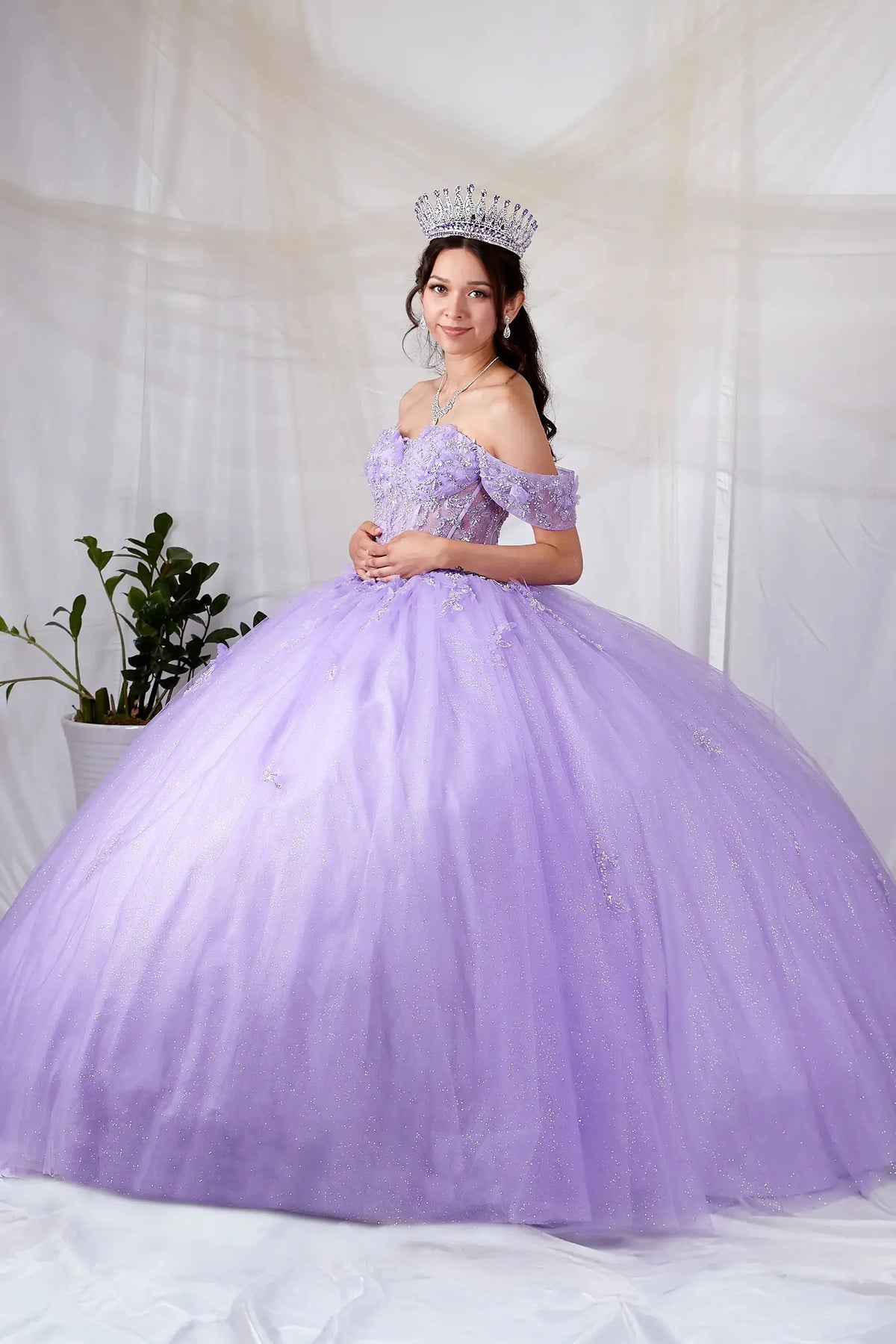 Lilac quinceañera ball gown with sheer bodice, butterfly applique and glitter tulle skirt