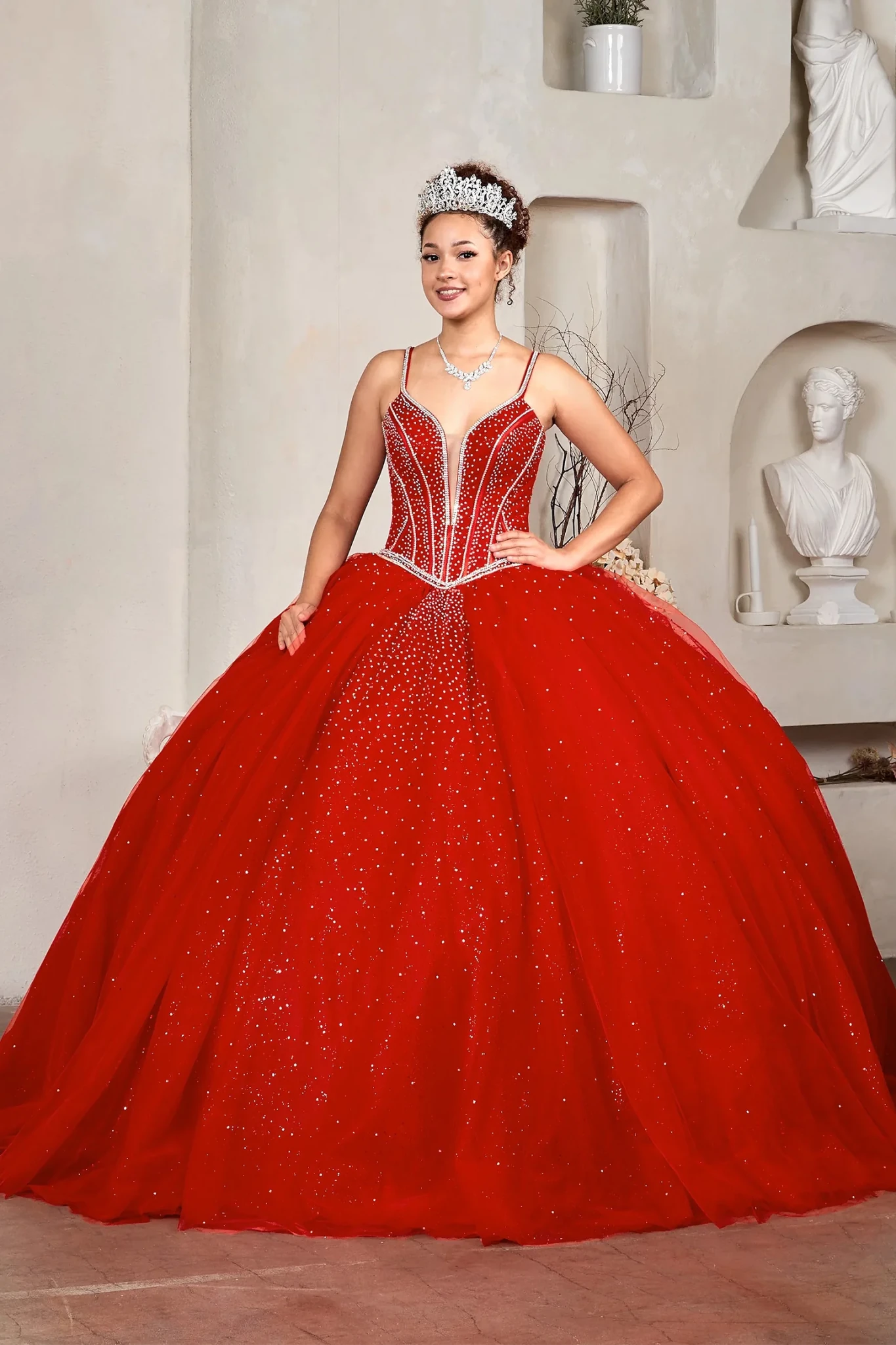 Red quinceañera ball gown with crystal beaded embroidery, glitter tulle skirt and spaghetti strap corset bodice