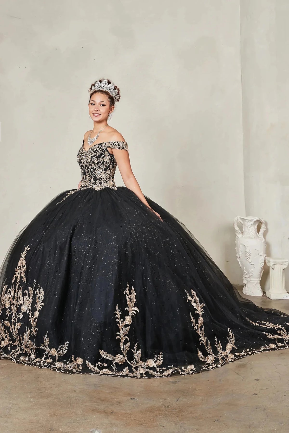 Black quinceañera ball gown with gold embroidered bodice and glitter tulle overlay skirt