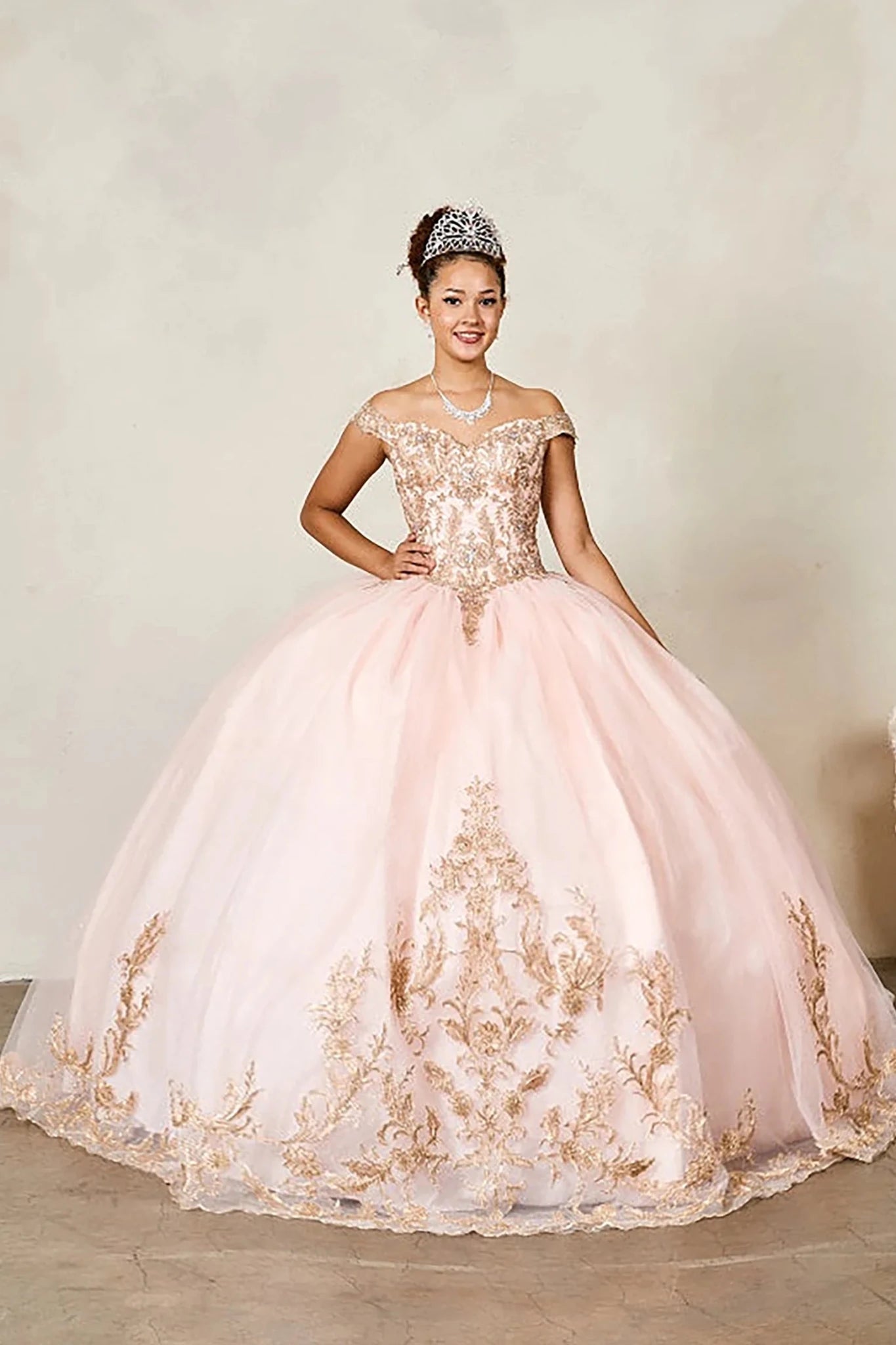 Blush quinceañera ball gown with gold embroidered bodice and glitter tulle overlay skirt