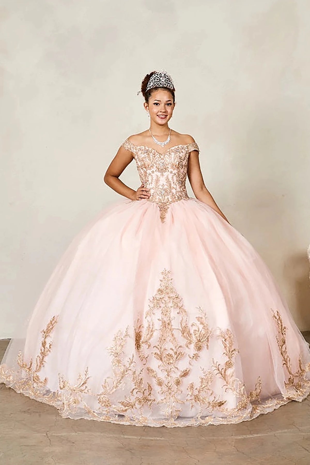 Blush quinceañera ball gown with gold embroidered bodice and glitter tulle overlay skirt