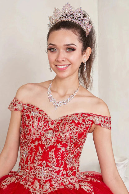 Bodice close-up highlights red quinceañera ball gown with off‑shoulder neckline, gold embroidered lace applique.
