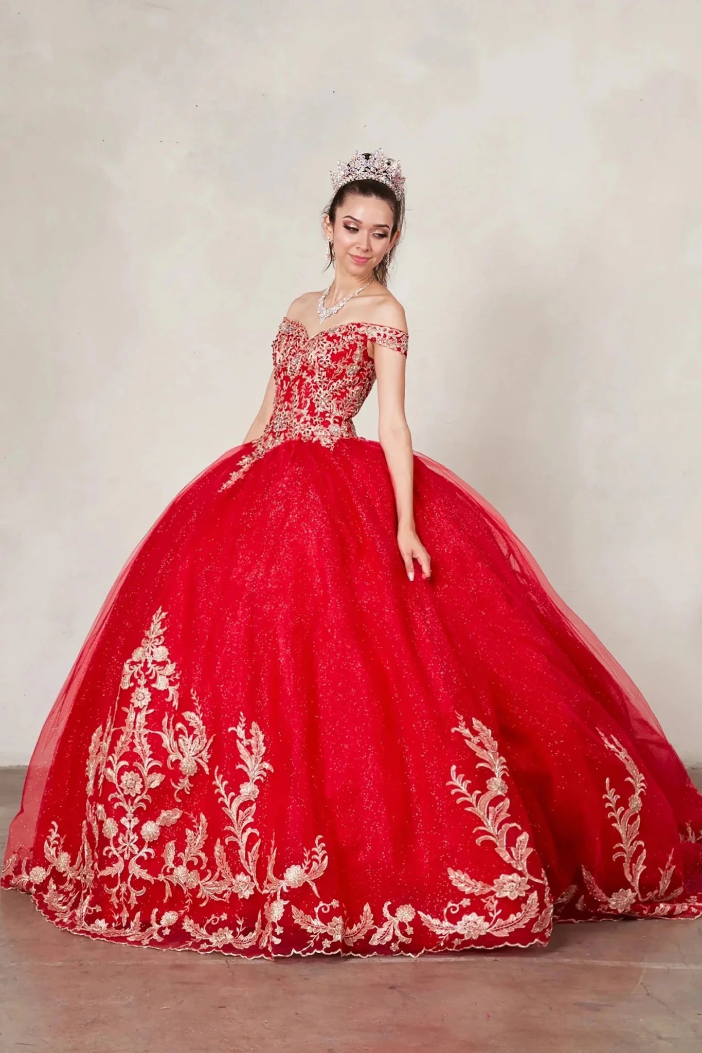 Red quinceañera ball gown with gold embroidered lace applique, glitter tulle overlay and A‑line silhouette