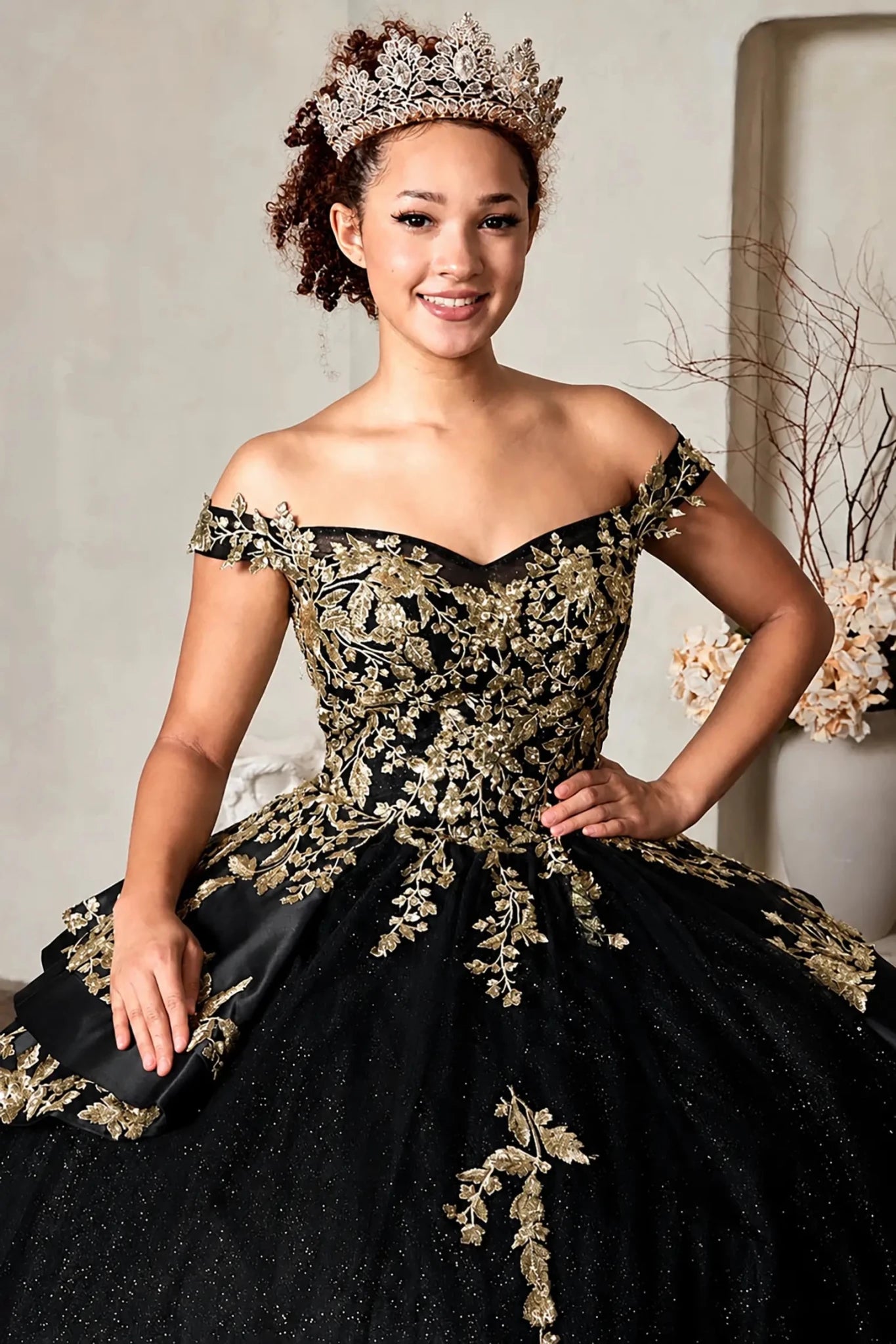 black off-the-shoulder quinceanera ball gown with ornate gold floral embroidery
