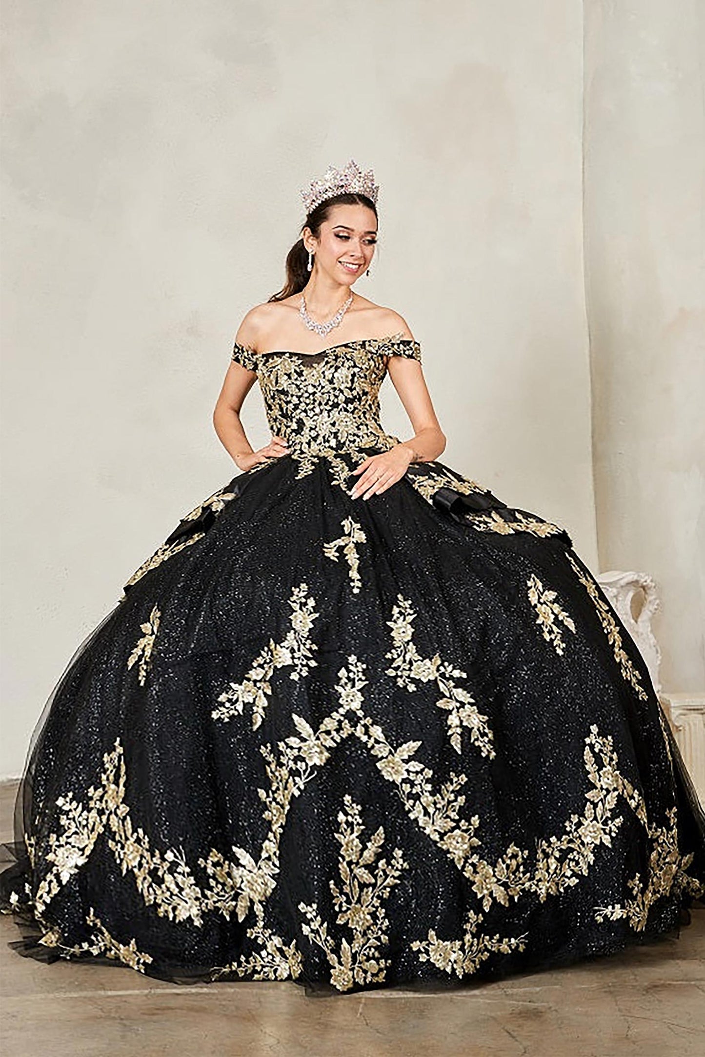 Black quinceañera ball gown with beaded gold embroidery, glitter layered skirt and lace‑up corset