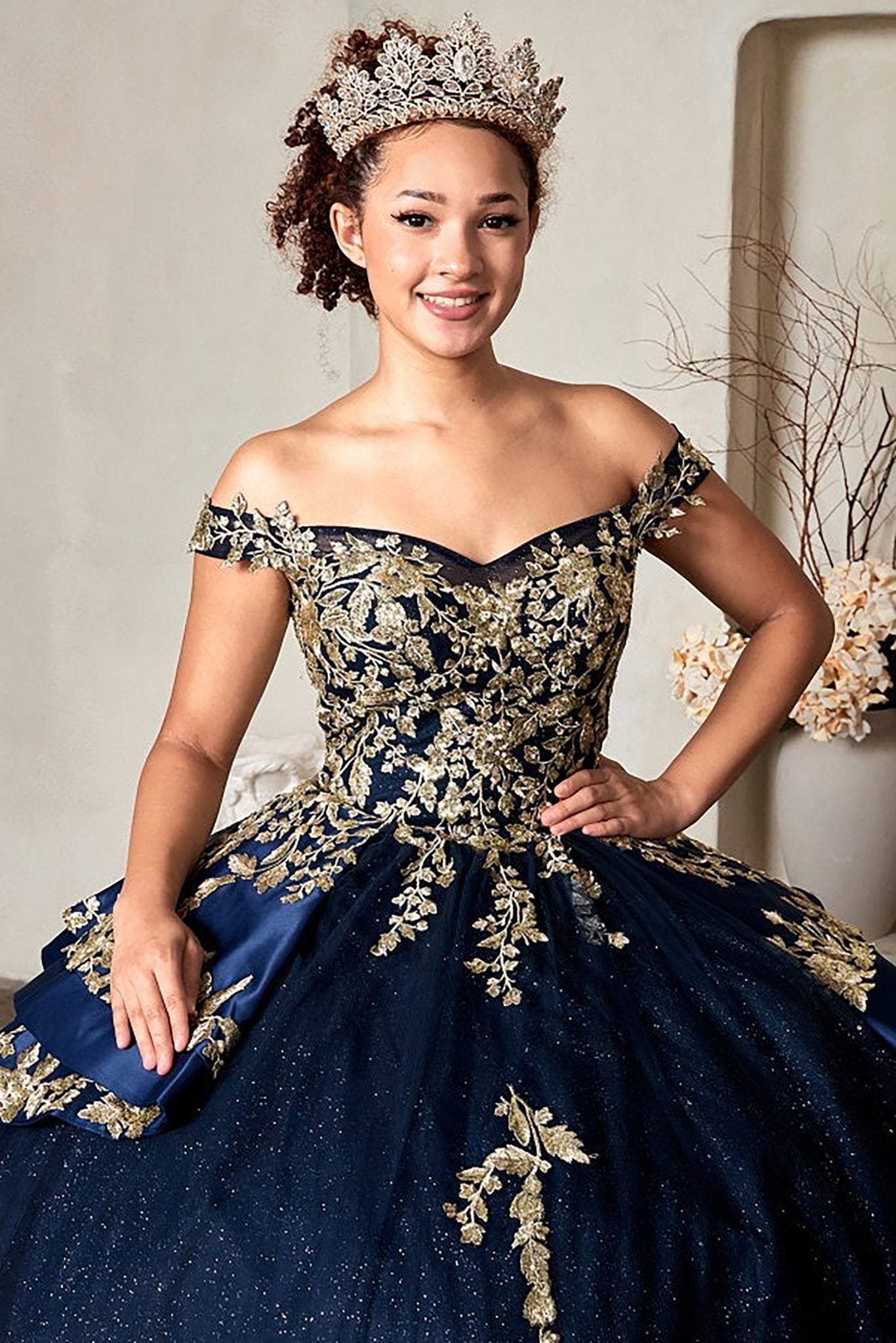Navy quinceañera ball gown with beaded gold embroidery, glitter layered skirt and lace‑up corset