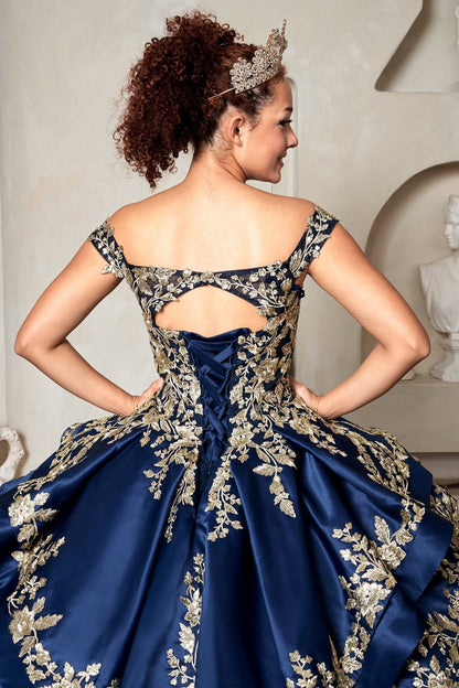 Hemline view highlights navy quinceañera ball gown with beaded gold embroidery, glitter layered skirt and lace‑up corset.