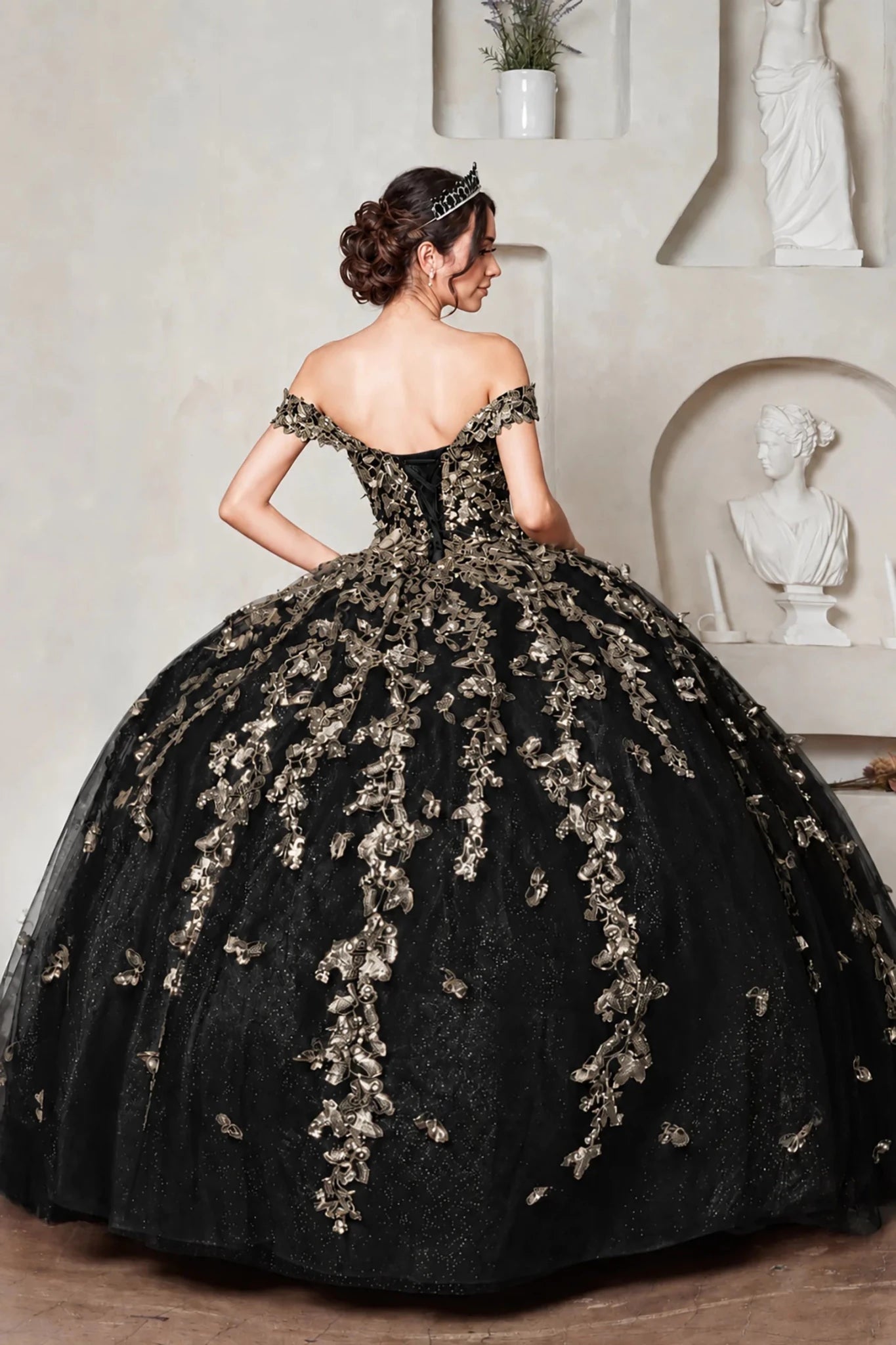 off-the-shoulder black quinceanera ball gown with elaborate gold floral embroidery and lace up back