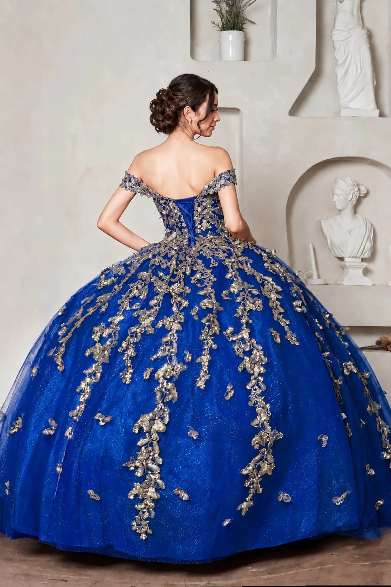 royal blue off-the-shoulder quinceanera ball gown with gold floral embroidery and lace up back