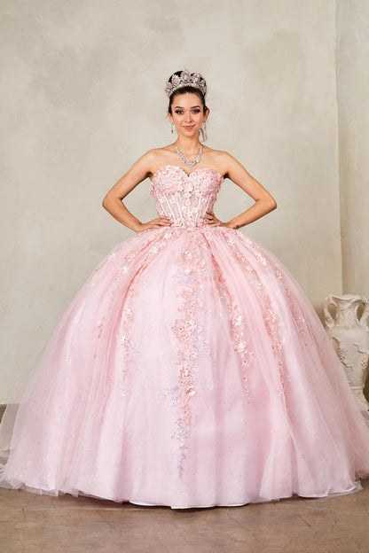 Front view of a woman wearing a blush quinceañera dress with glitter tulle and 3D floral flowers
