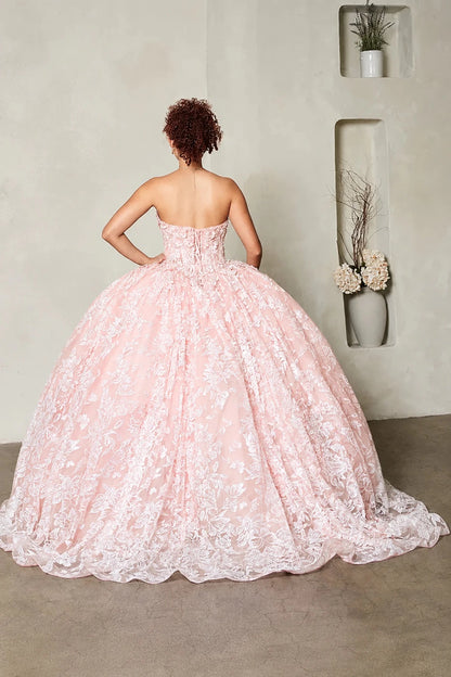  a strapless blush pink quince ball gown with intricate lace applique, lace up back and a full voluminous skirt