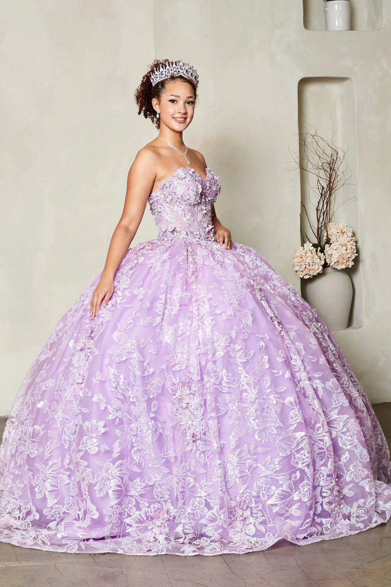 voluminous lavender quinceañera ball gown with white floral lace applique, a strapless sweetheart bodice