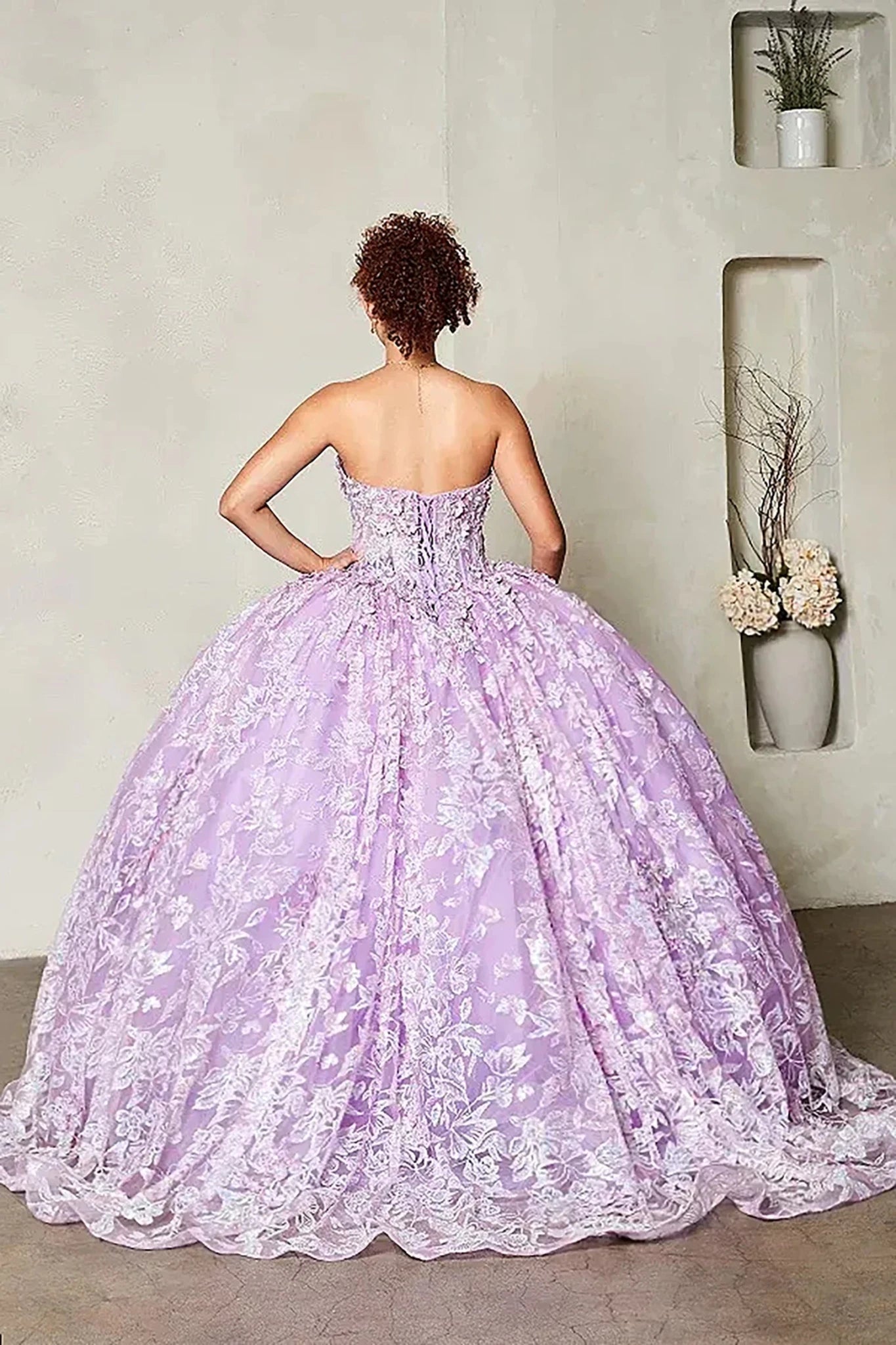 a strapless lavender ball gown with intricate floral lace applique and a full voluminous skirt