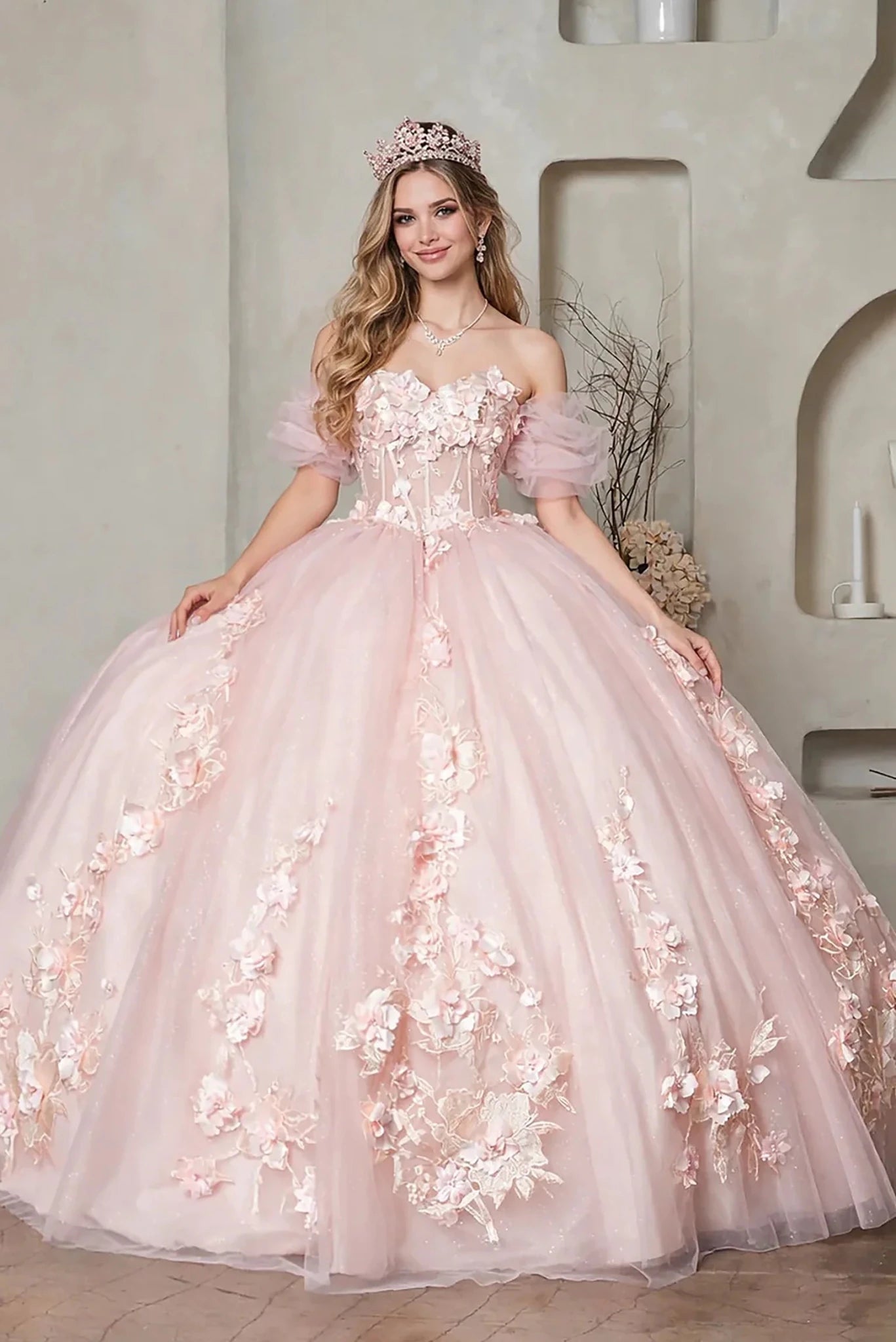 a voluminous light pink quinceanera ball gown with floral appliqué, puff sleeves