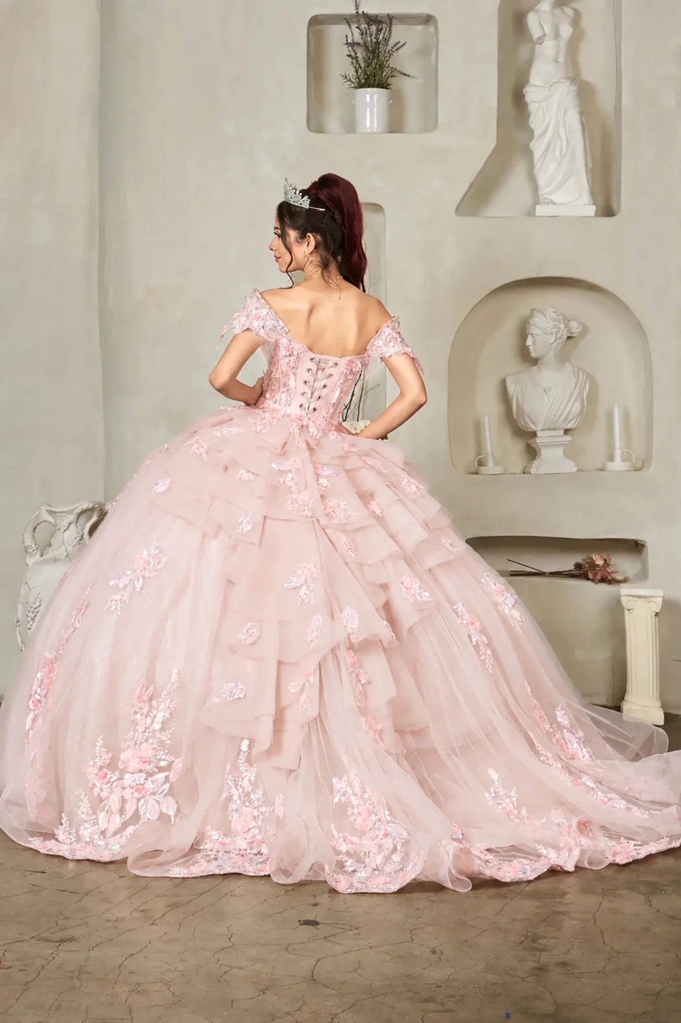 Blush quinceañera ball gown with floral applique, crystal beaded bodice, layered ruffles and lace‑up back