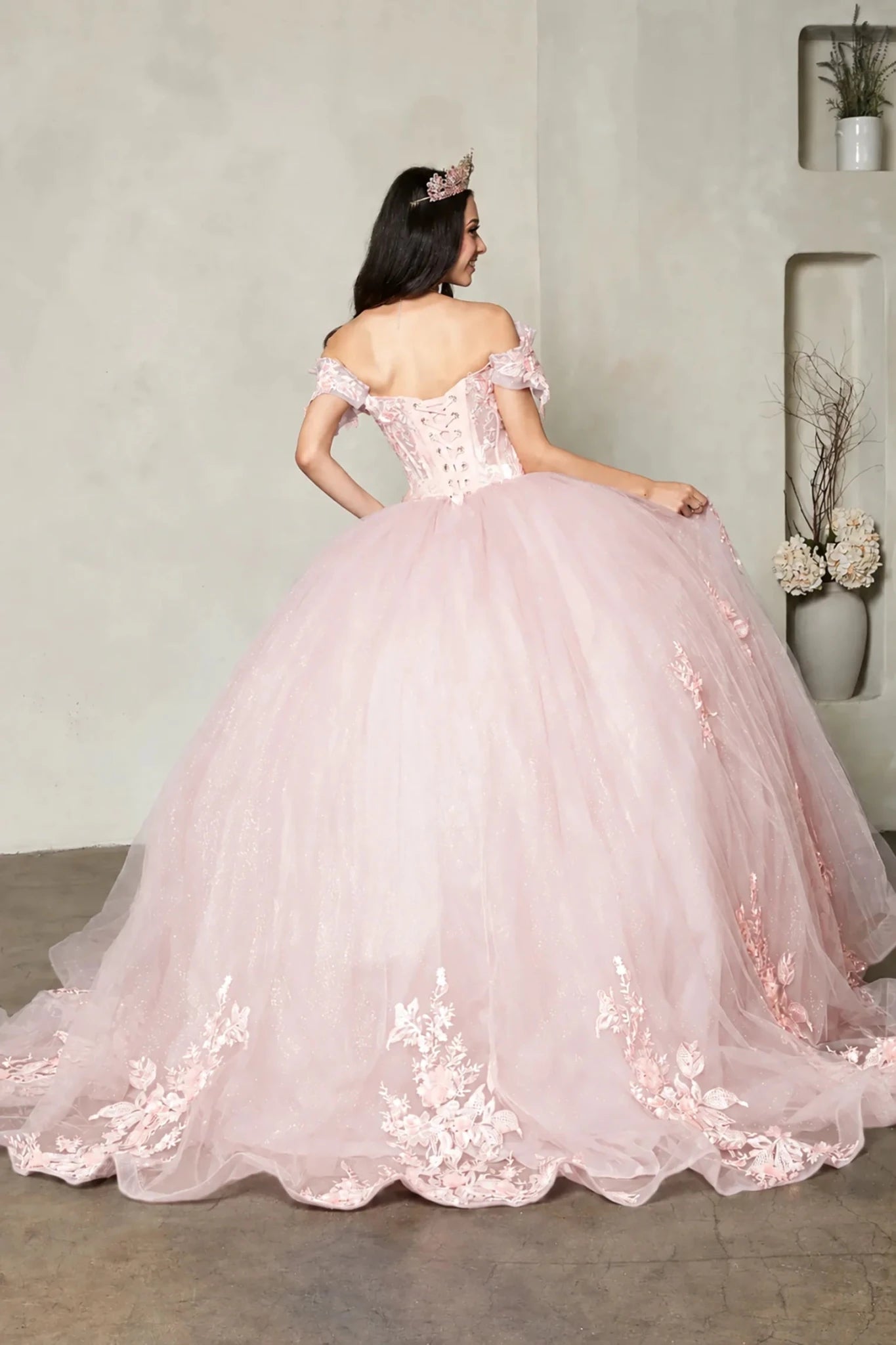 Blush quinceañera ball gown with off‑shoulder straps, crystal beaded bodice and floral applique