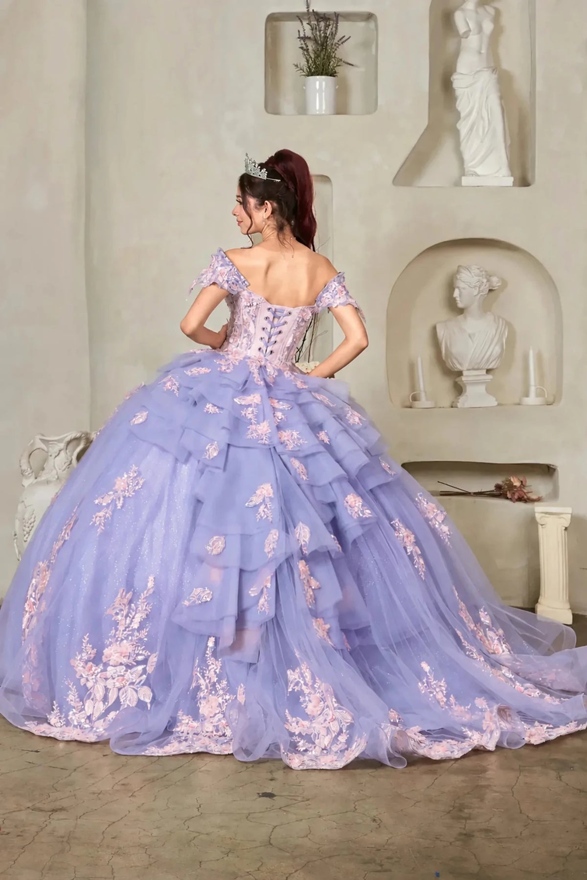 Lilac quinceañera ball gown with blush floral embroidery, layered ruffles and lace‑up back