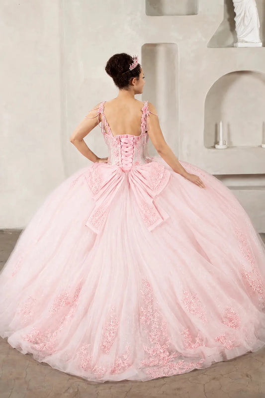 a voluminous blush quinceanera ball gown with a corset-style lace-up back and long train