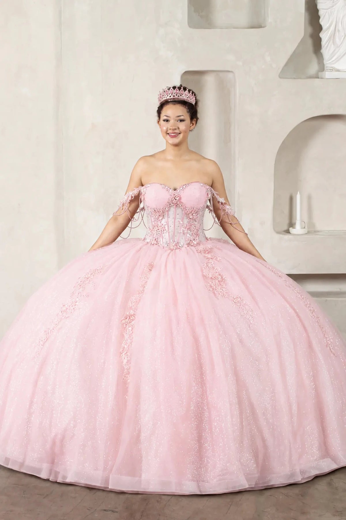 Blush quinceañera ball gown with 3D floral embroidery, jeweled off‑shoulder sleeves and detachable bow