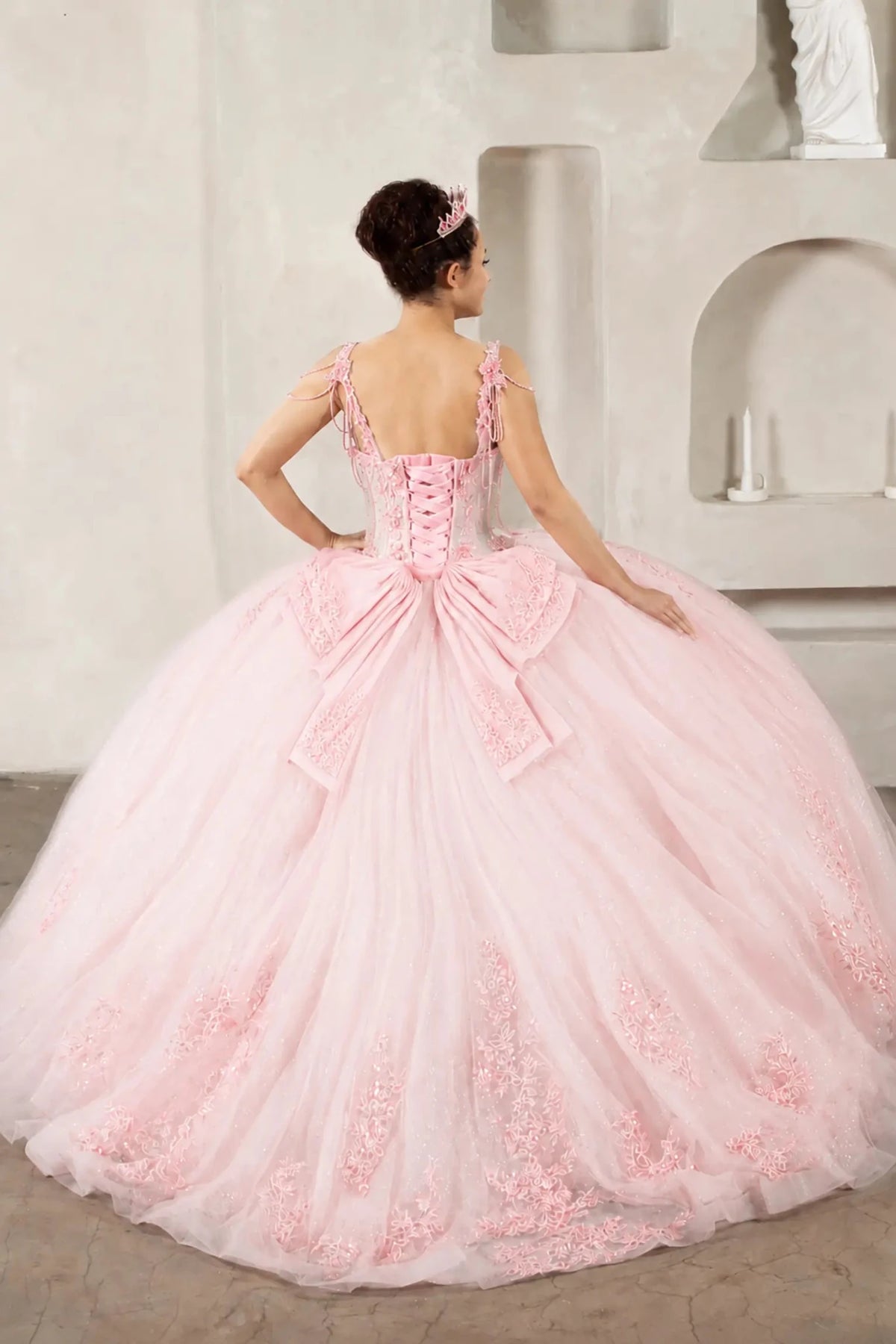 Blush quinceañera ball gown with sheer corset bodice, 3D floral embroidery, detachable bow and sparkle tulle