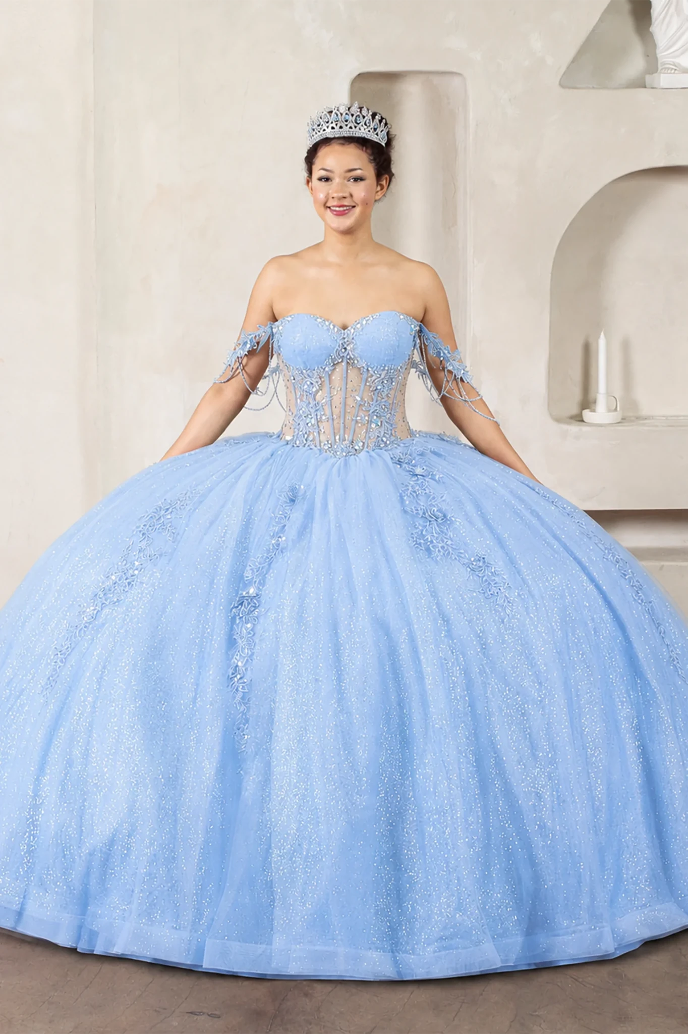 Light blue quinceañera ball gown with sheer bodice, floral embroidery, detachable bow and sparkle tulle