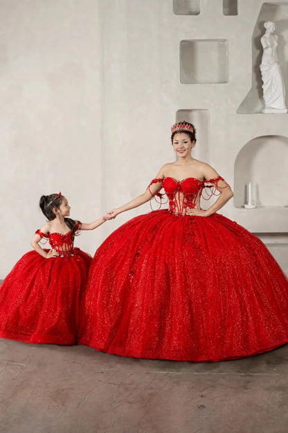 A woman and a young girl wearing matching voluminous red ballgown quinceañera dresses 