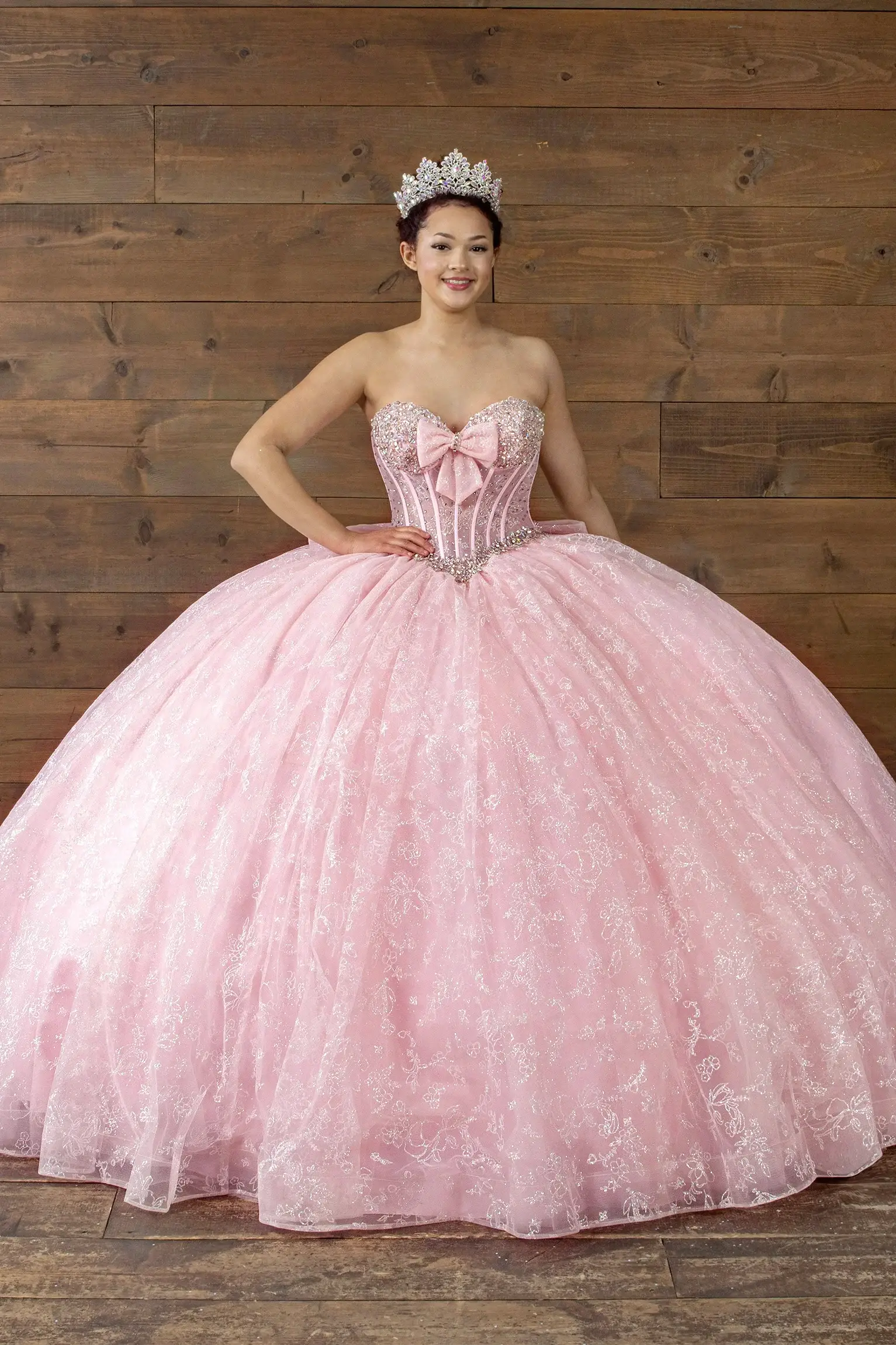 Front-Facing of a woman wearing Bubble pink strapless ball gown with sweetheart neckline beaded bodice floral appliqués and glitter tulle skirt