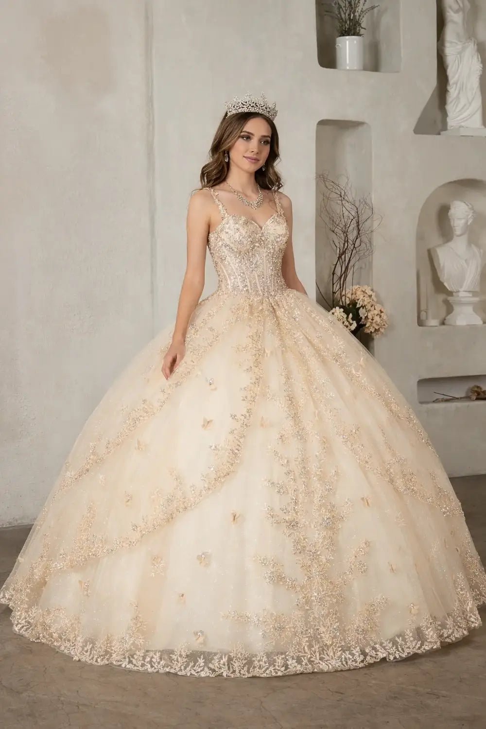 Champagne quinceañera ball gown with 3D butterfly applique, sheer bodice, spaghetti straps and lace skirt