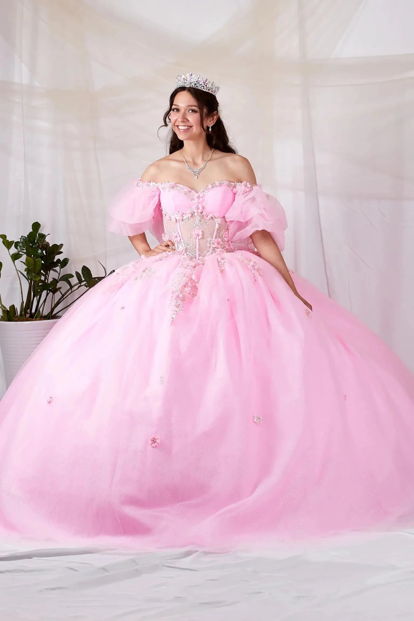 Blush quinceañera ball gown with 3D floral applique, sheer bodice, off‑shoulder neckline and lace skirt