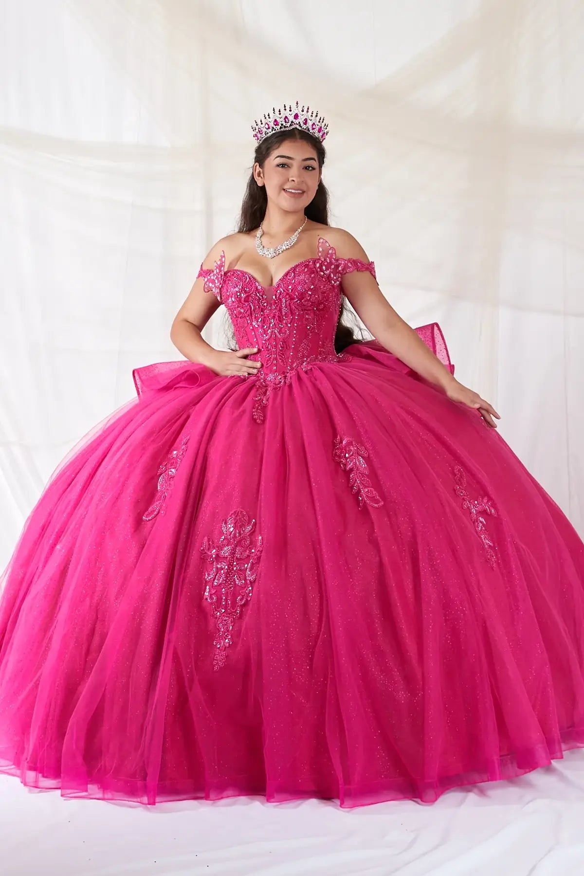 Fuchsia quinceañera ball gown with 3D butterfly sleeves, embroidered bodice and glitter tulle skirt