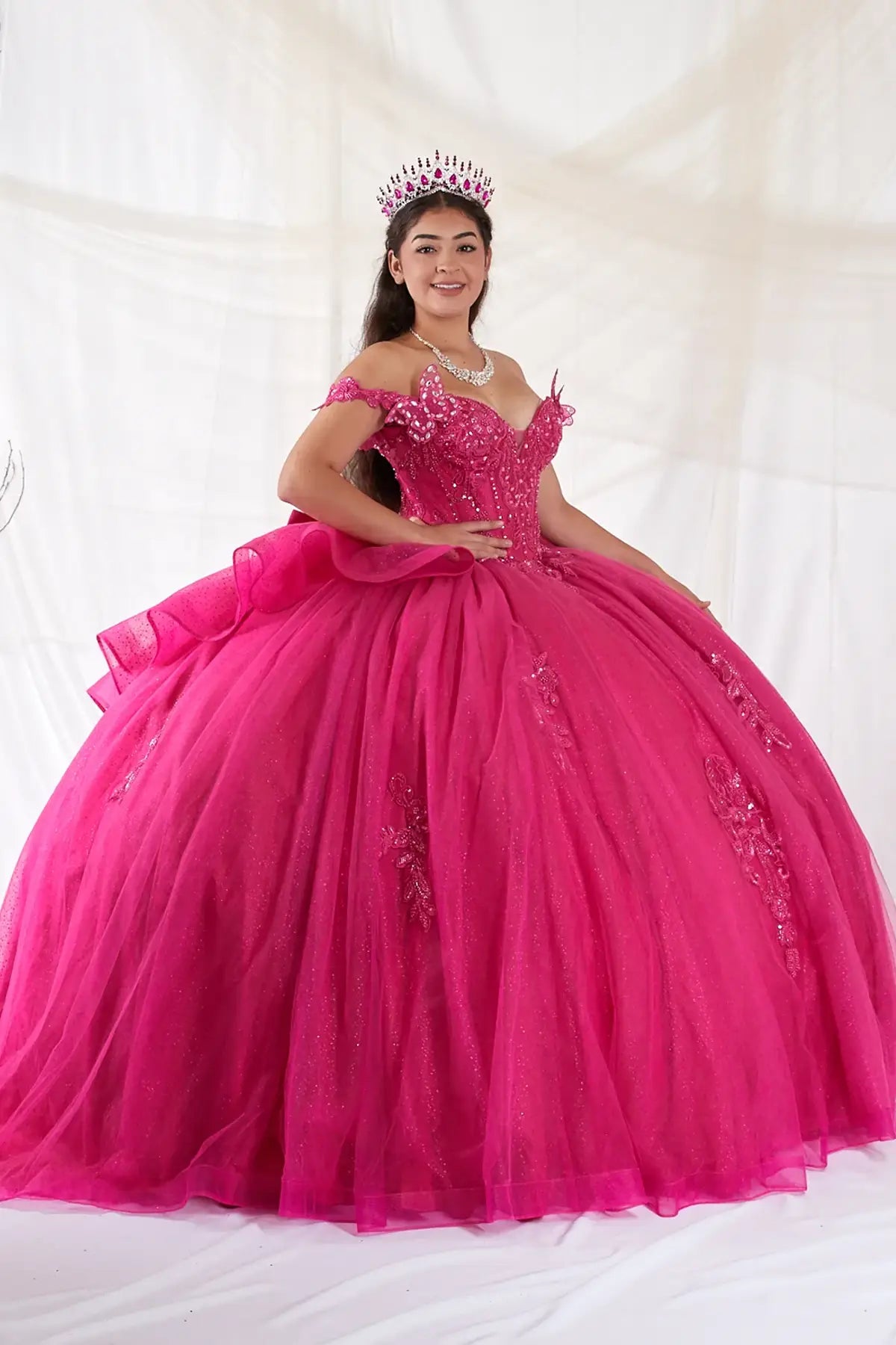 Fuchsia quinceañera ball gown with 3D butterfly sleeves, embroidered bodice and glitter tulle skirt