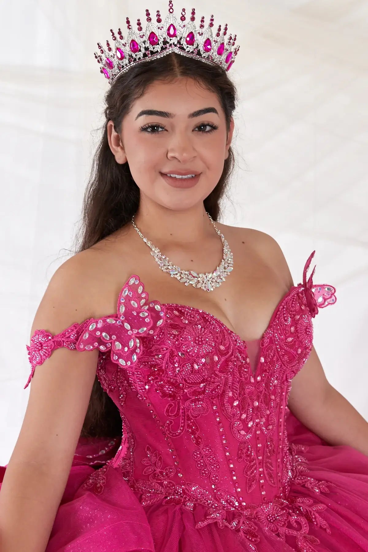 Fuchsia quinceañera ball gown with 3D butterfly sleeves, embroidered bodice and glitter tulle skirt