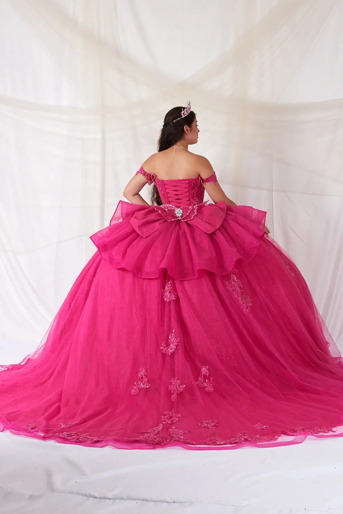 Fuchsia quinceañera ball gown with 3D butterfly sleeves, embroidered bodice and glitter tulle skirt