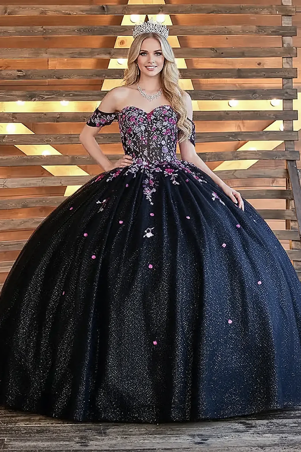 Black quinceañera ball gown with multicolor floral sheer bodice, basque waist and detachable bow