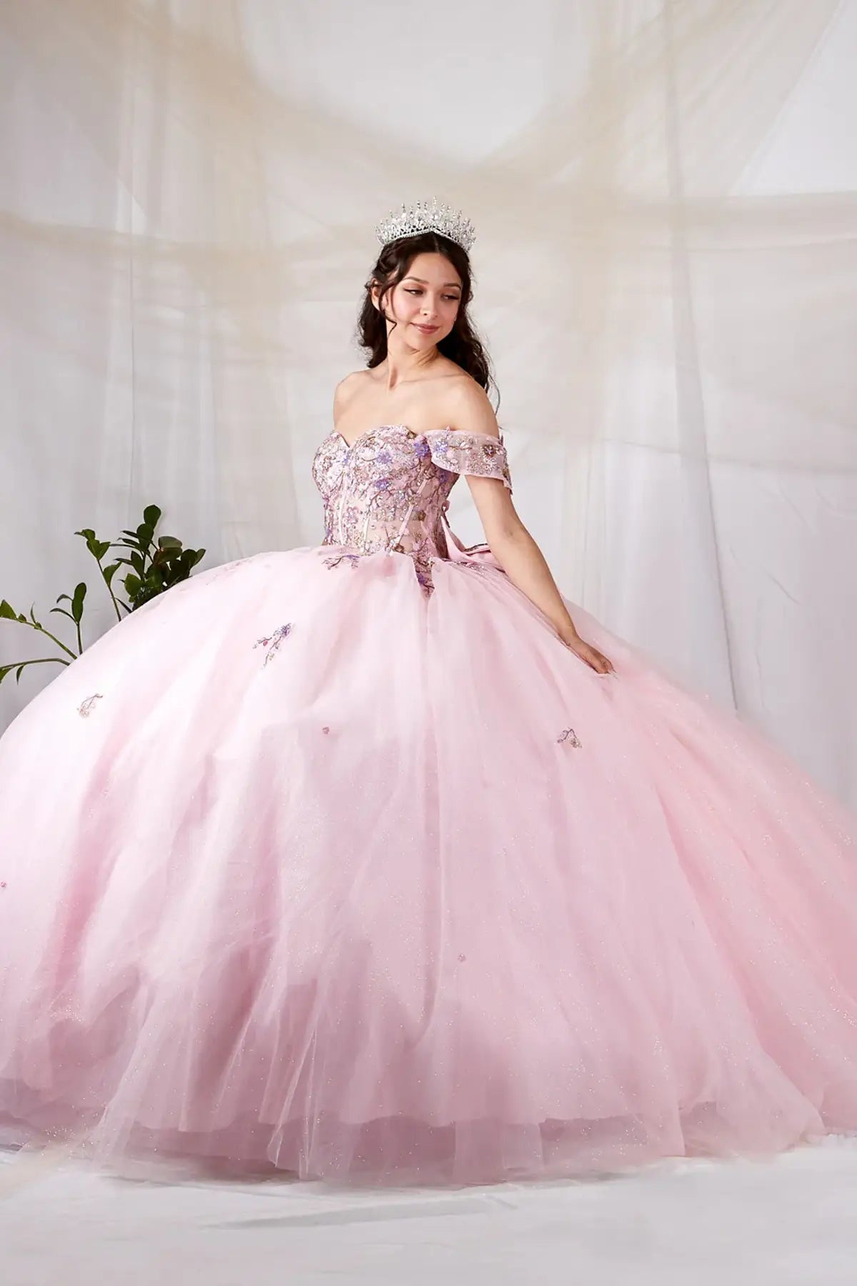 Blush quinceañera ball gown with multicolor floral sheer bodice, basque waist and detachable bow