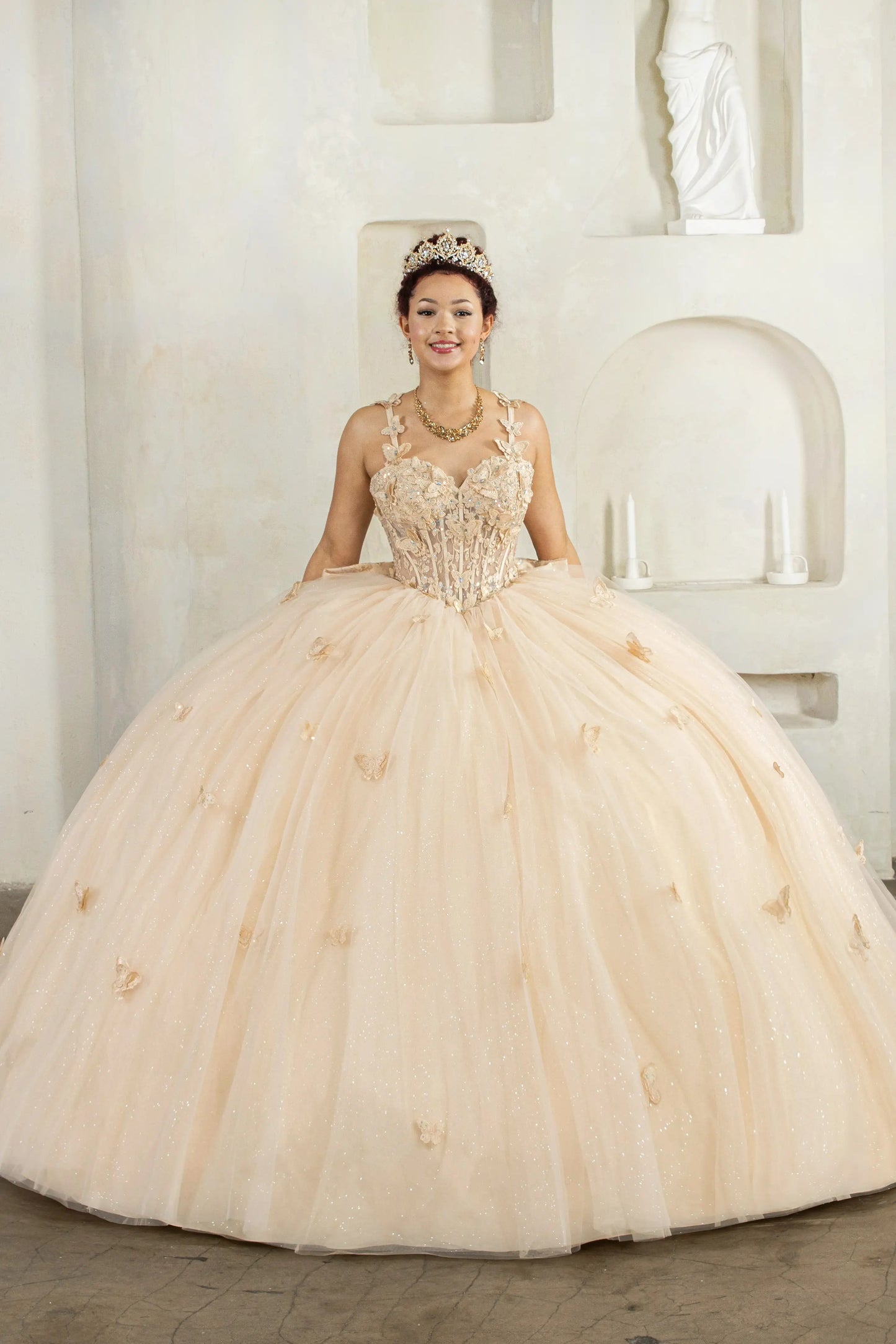 Champagne quinceañera ball gown with 3D butterfly straps, layered tulle skirt and detachable bow