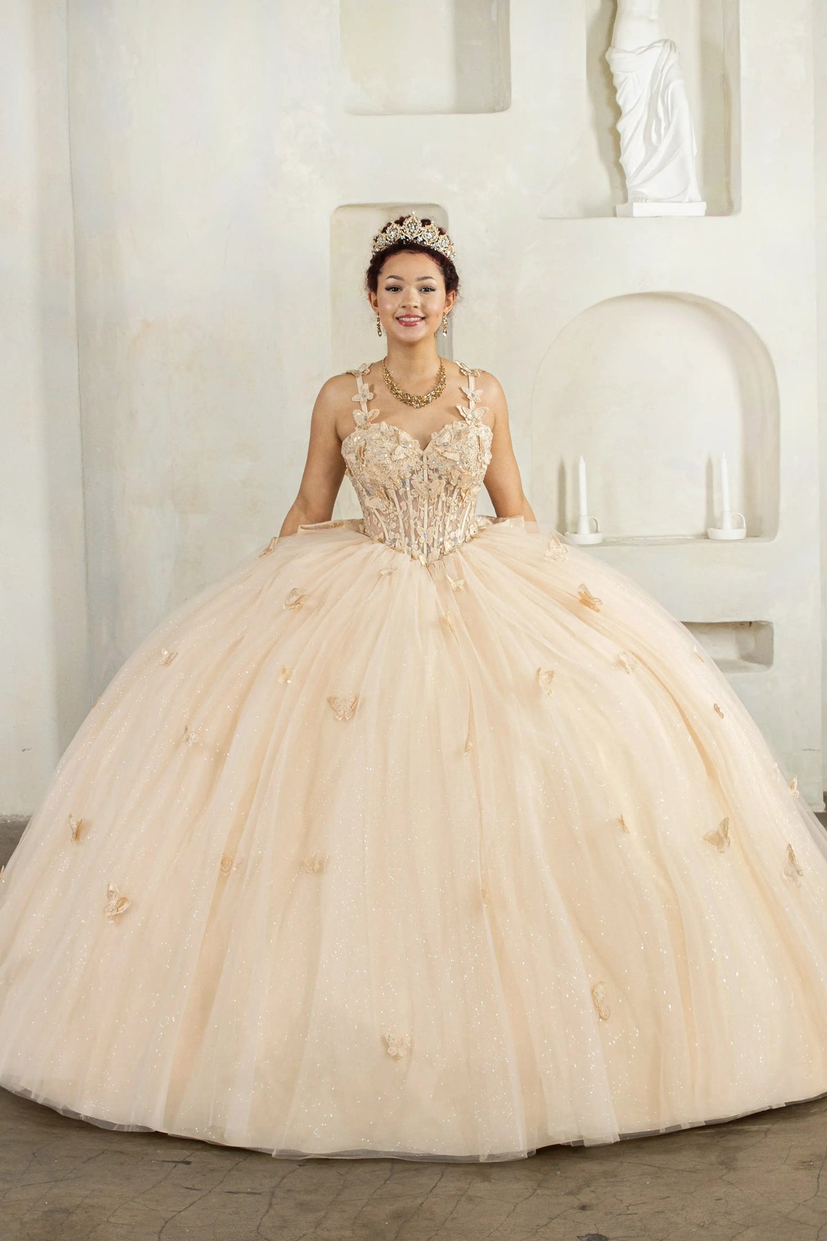 Champagne quinceañera ball gown with 3D butterfly straps, layered tulle skirt and detachable bow