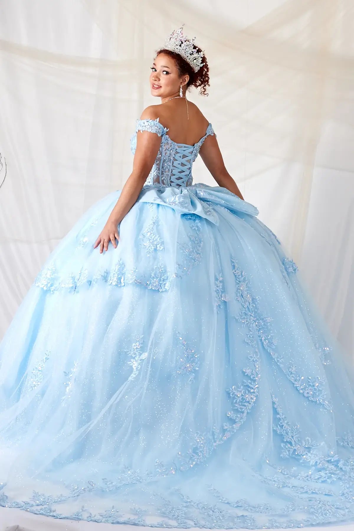 Bahama blue quinceañera ball gown with sheer sweetheart bodice, floral embroidery and glitter tulle skirt