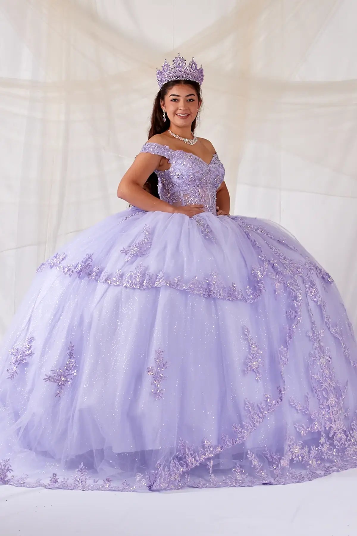Lilac quinceañera ball gown with sheer sweetheart bodice, floral embroidery and glitter tulle skirt