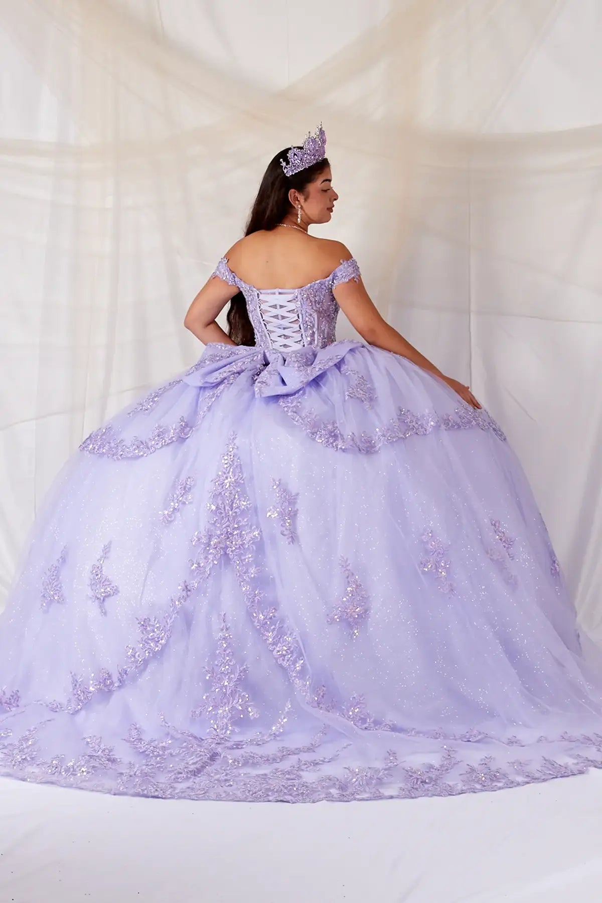Lilac quinceañera ball gown with sheer sweetheart bodice, floral embroidery and glitter tulle skirt